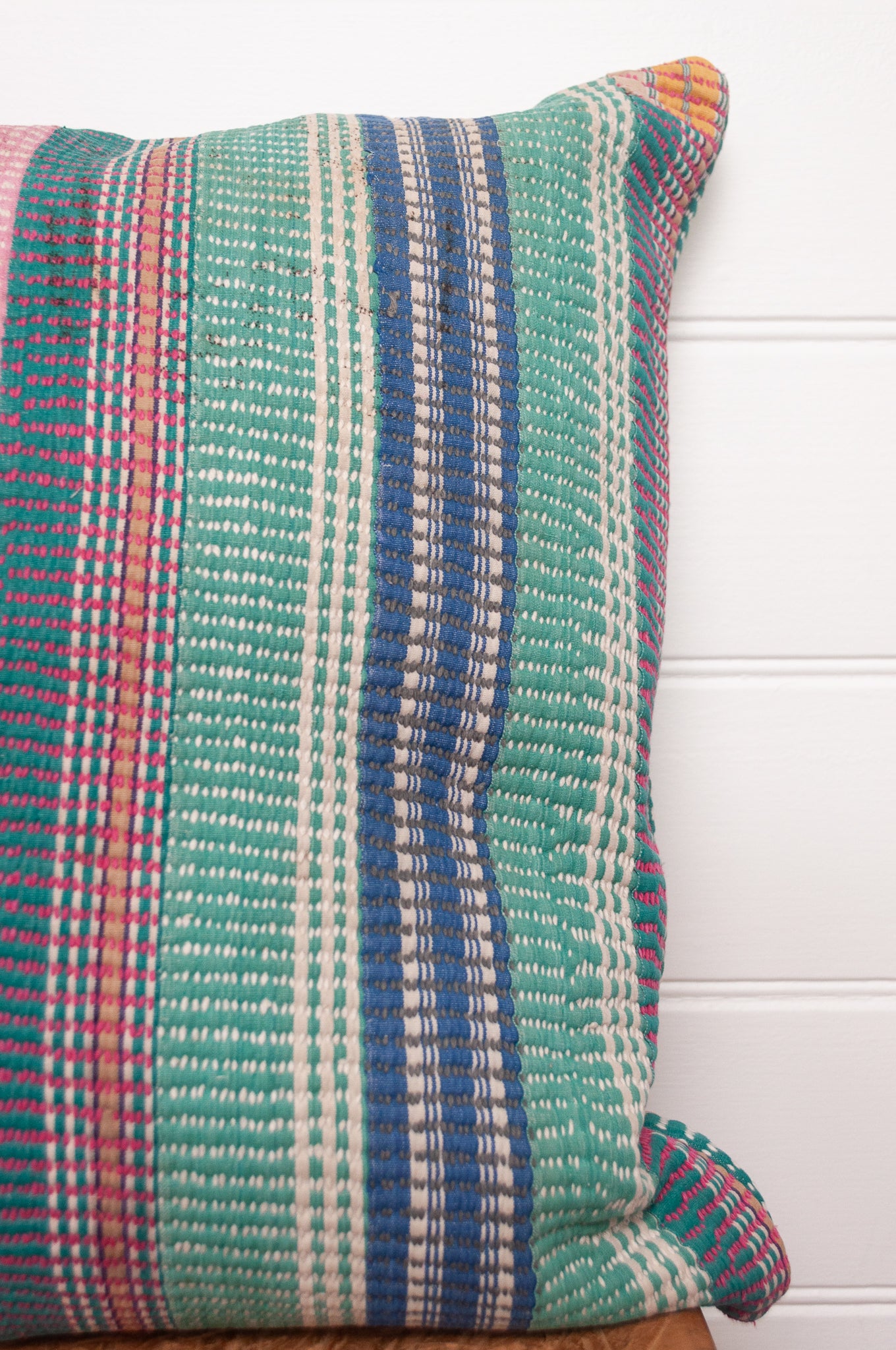 Vintage kantha cushion with stripes in pink, blue and green, finely stitched.