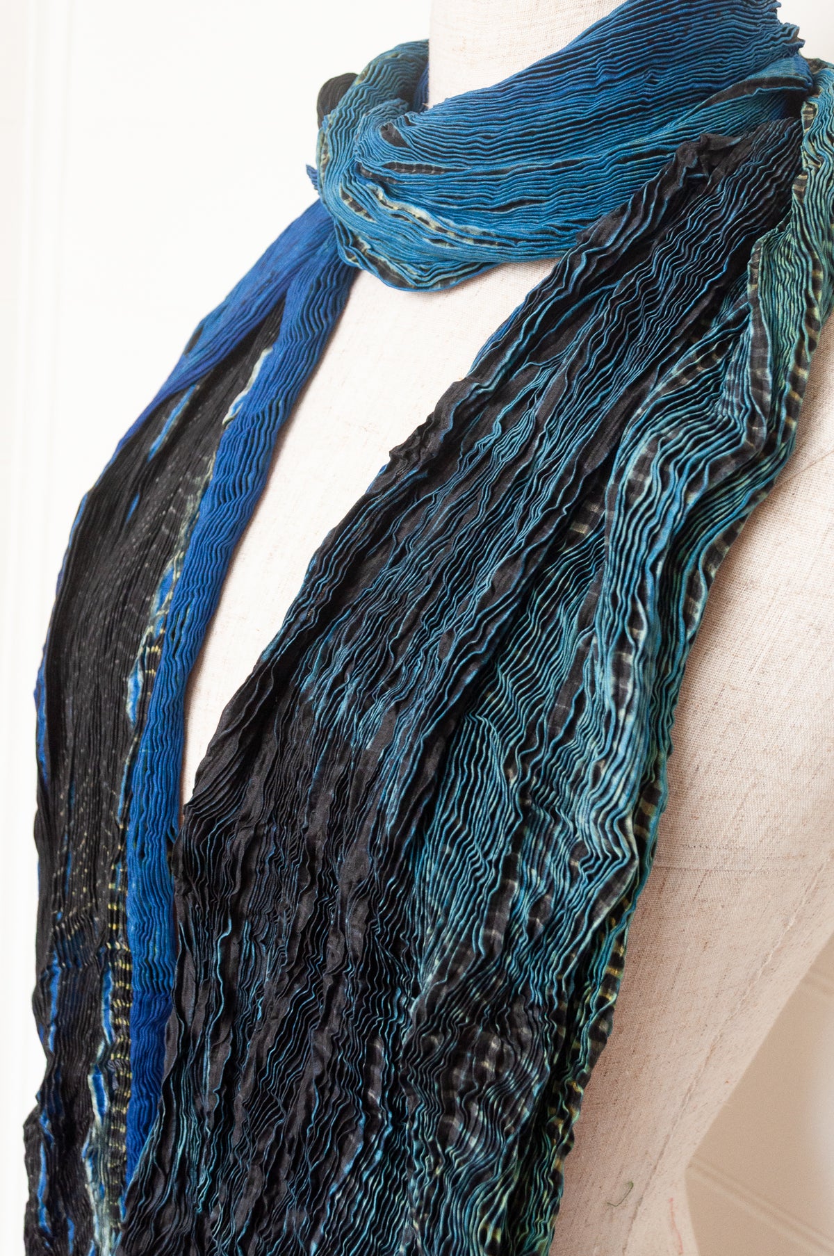 Neeru Kumar shibori dyed pure silk crinkle scarf in blues and greens with black and white speckled details.