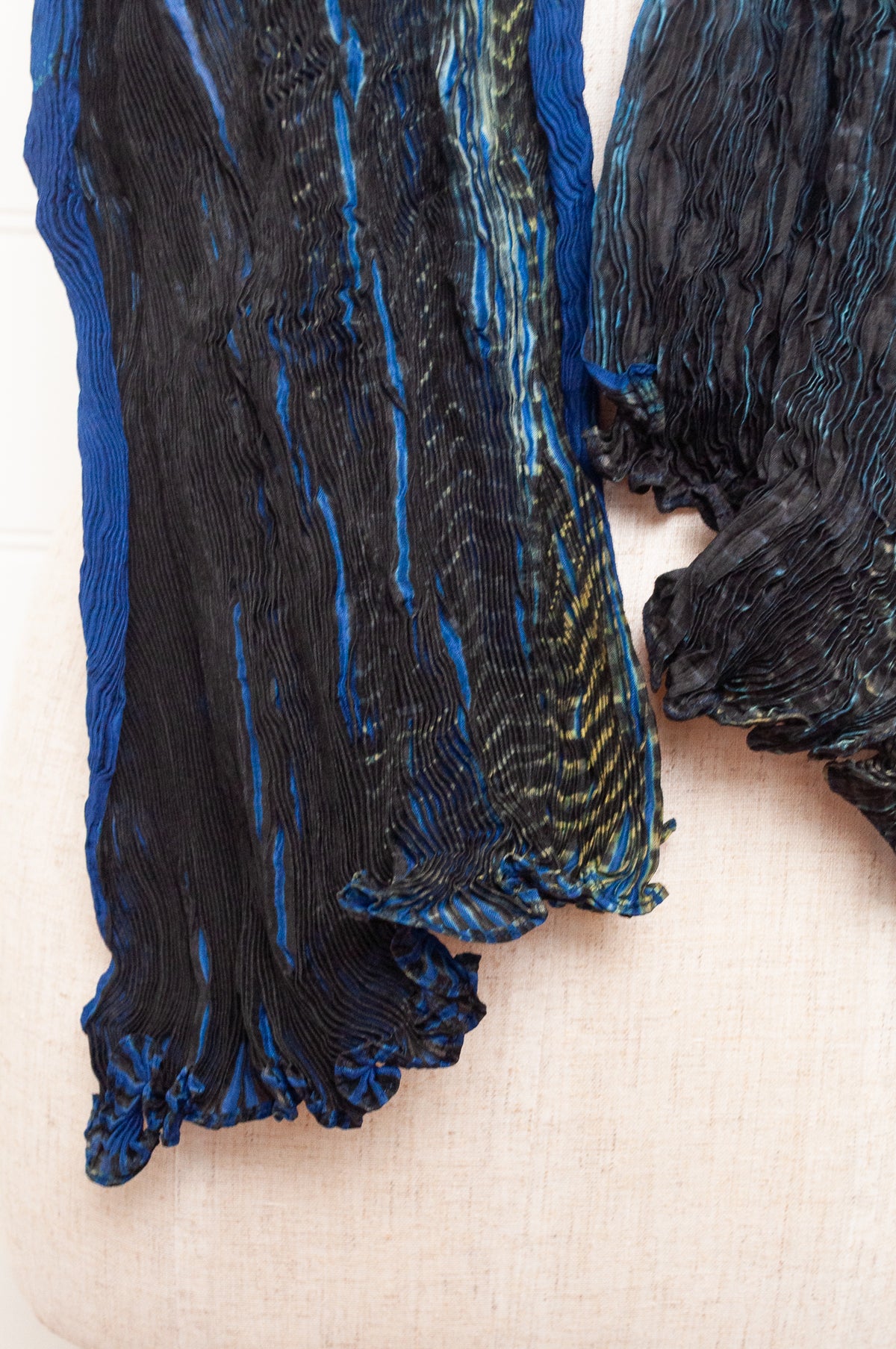 Neeru Kumar shibori dyed pure silk crinkle scarf in blues and greens with black and white speckled details.