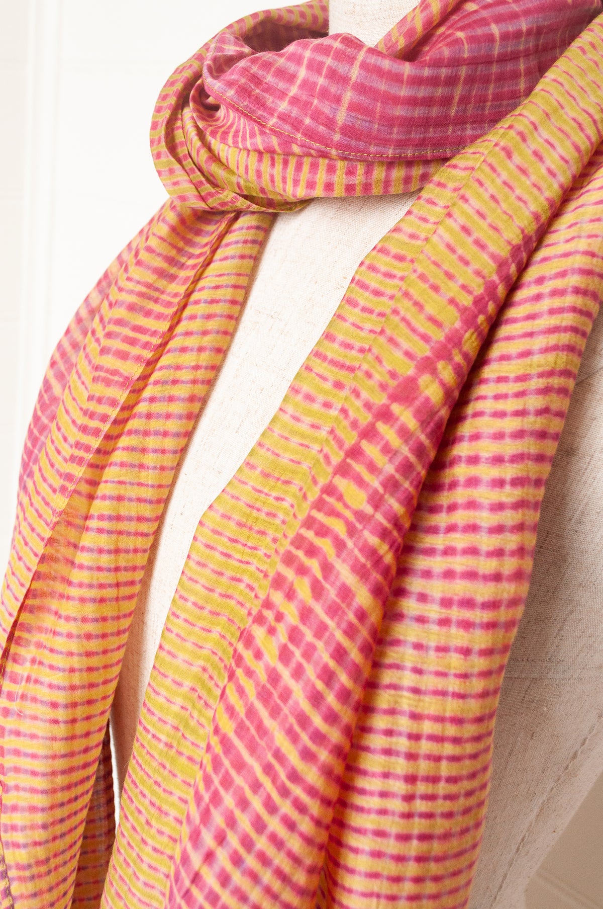 Neeru Kumar shibori dyed cotton silk scarf in raspberry pink and lime, with handmade tiny beads on the ends.