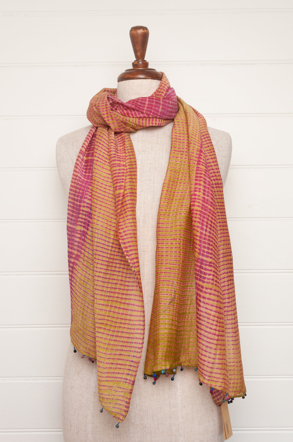 Neeru Kumar shibori dyed cotton silk scarf in raspberry pink and lime, with handmade tiny beads on the ends.