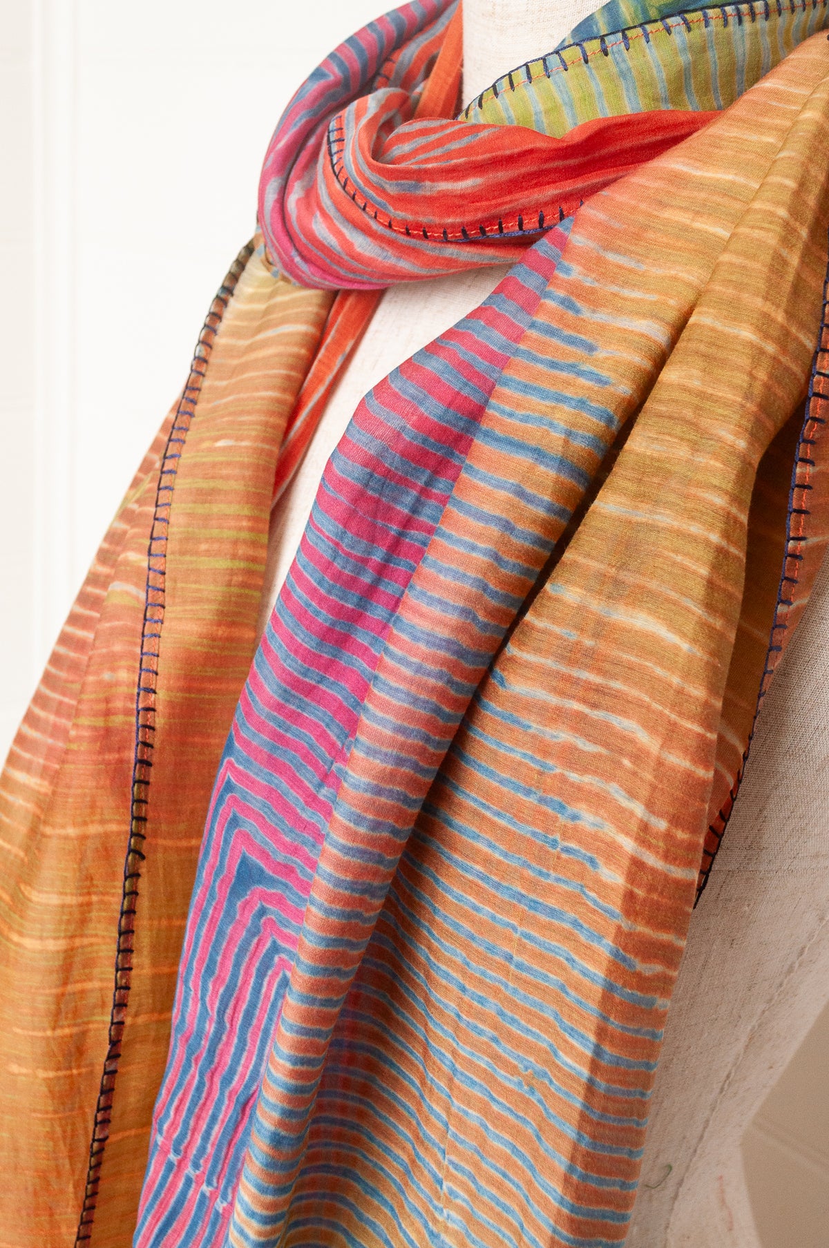 Neeru Kumar shibori dyed cotton silk scarf in rainbow colours, with navy handstitching and tassels.
