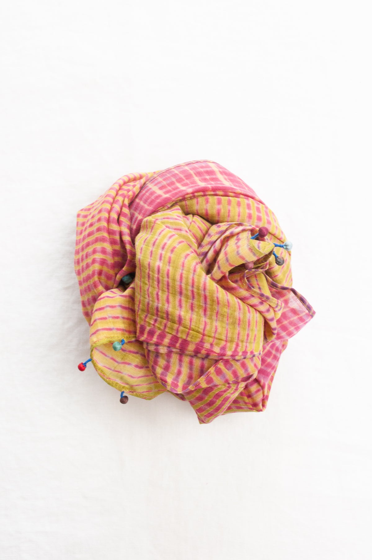 Neeru Kumar shibori dyed cotton silk scarf in raspberry pink and lime, with handmade tiny beads on the ends.