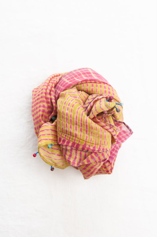 Neeru Kumar shibori dyed cotton silk scarf in raspberry pink and lime, with handmade tiny beads on the ends.