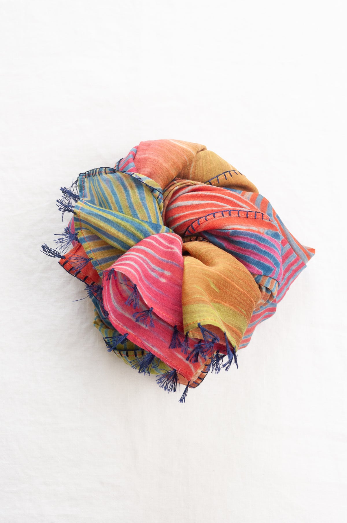 Neeru Kumar shibori dyed cotton silk scarf in rainbow colours, with navy handstitching and tassels.