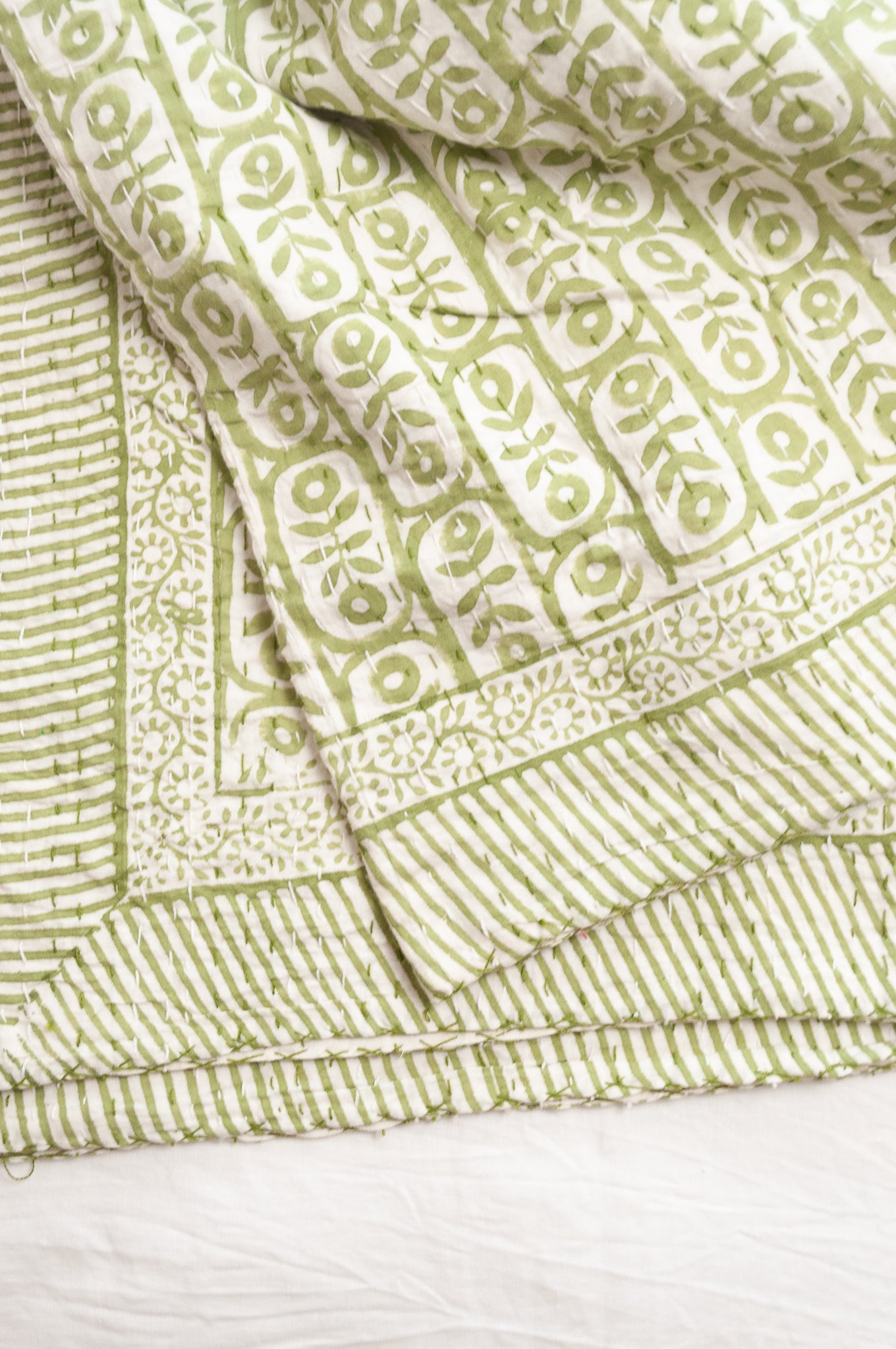 Kantha quilt blockprint pure cotton in floral sage green on white pattern.