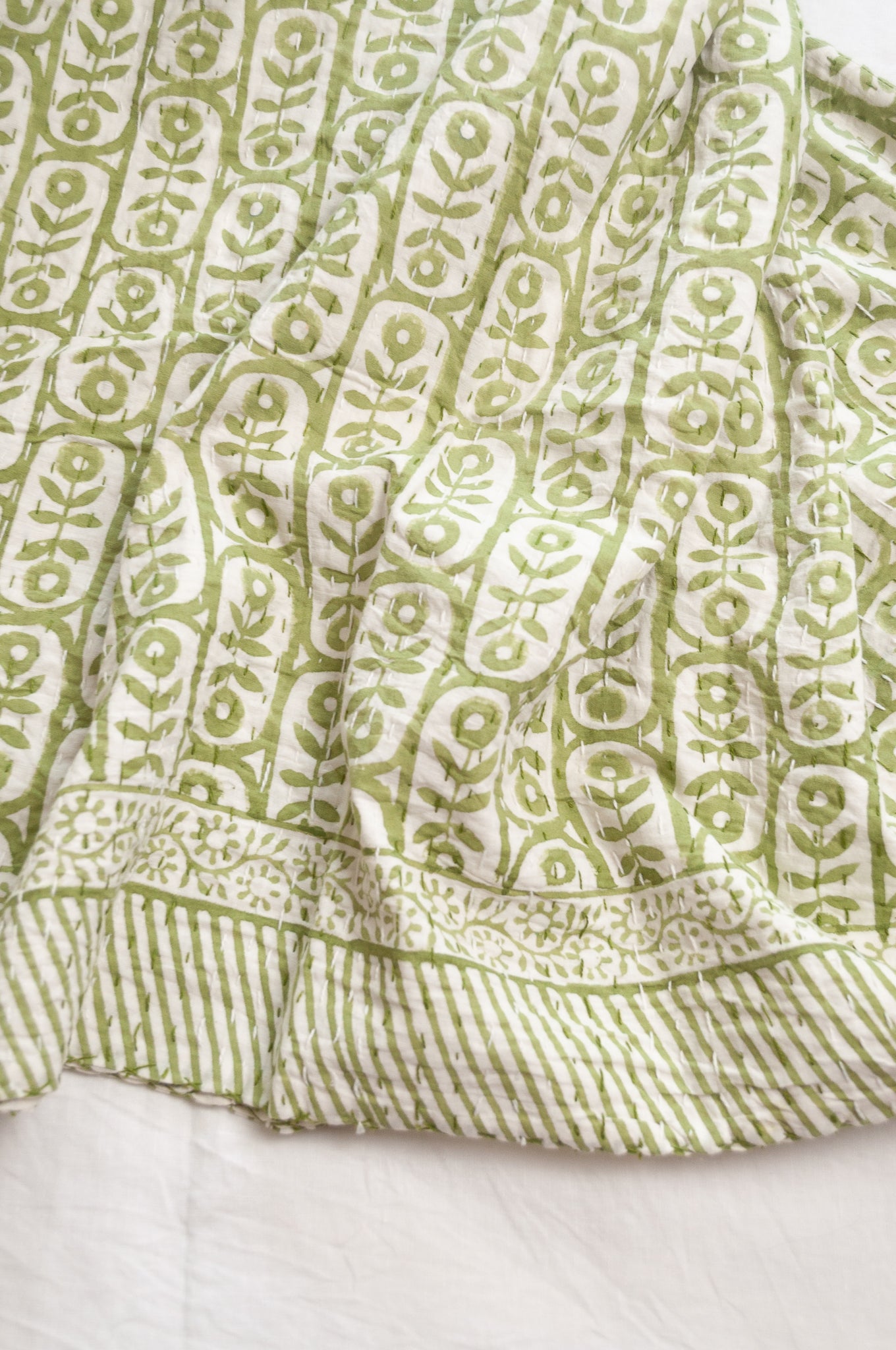 Kantha quilt blockprint pure cotton in floral sage green on white pattern.
