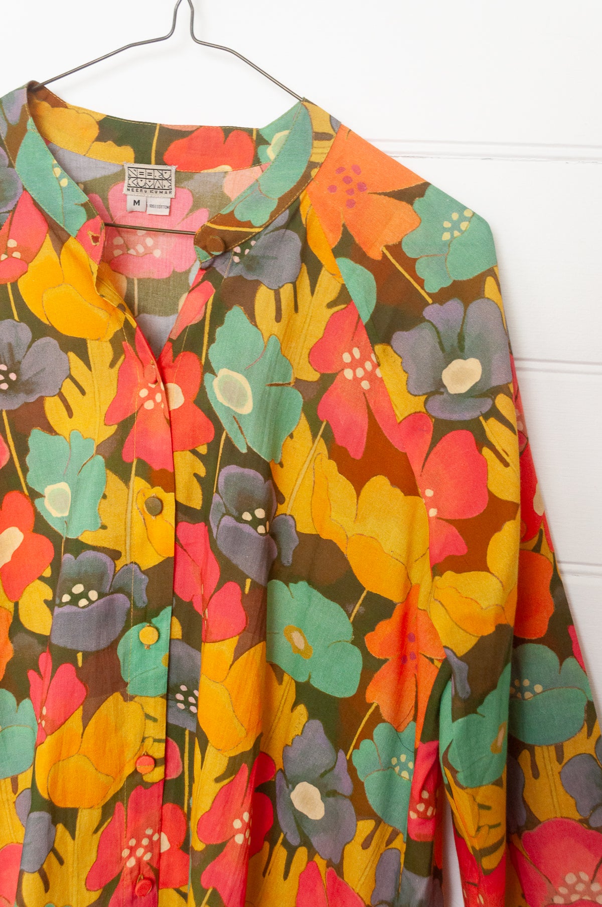 Neeru Kumar button-up shirt with a colorful floral pattern.