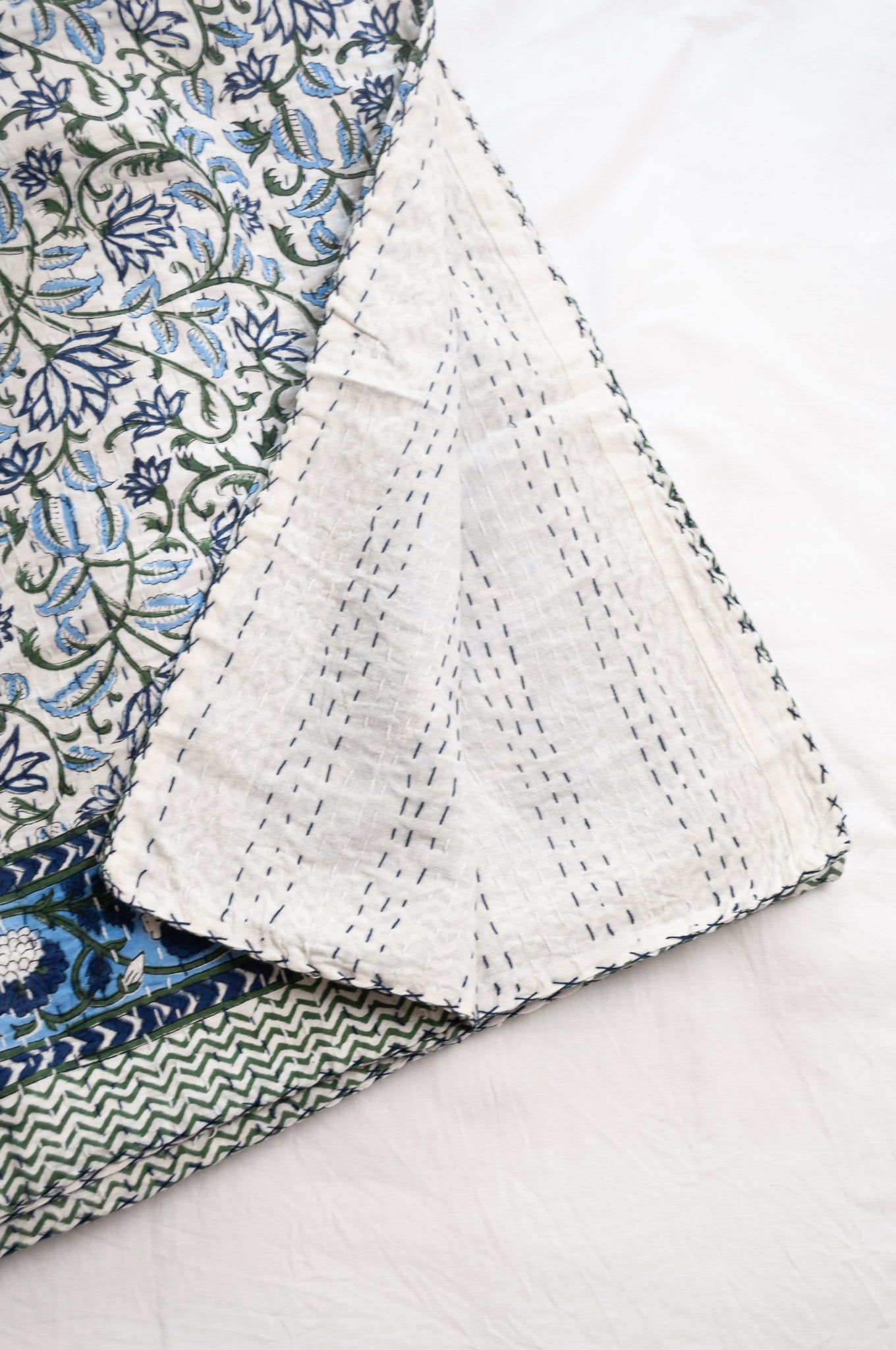 Kantha quilt blockprint pure cotton in floral blue and green on white pattern.