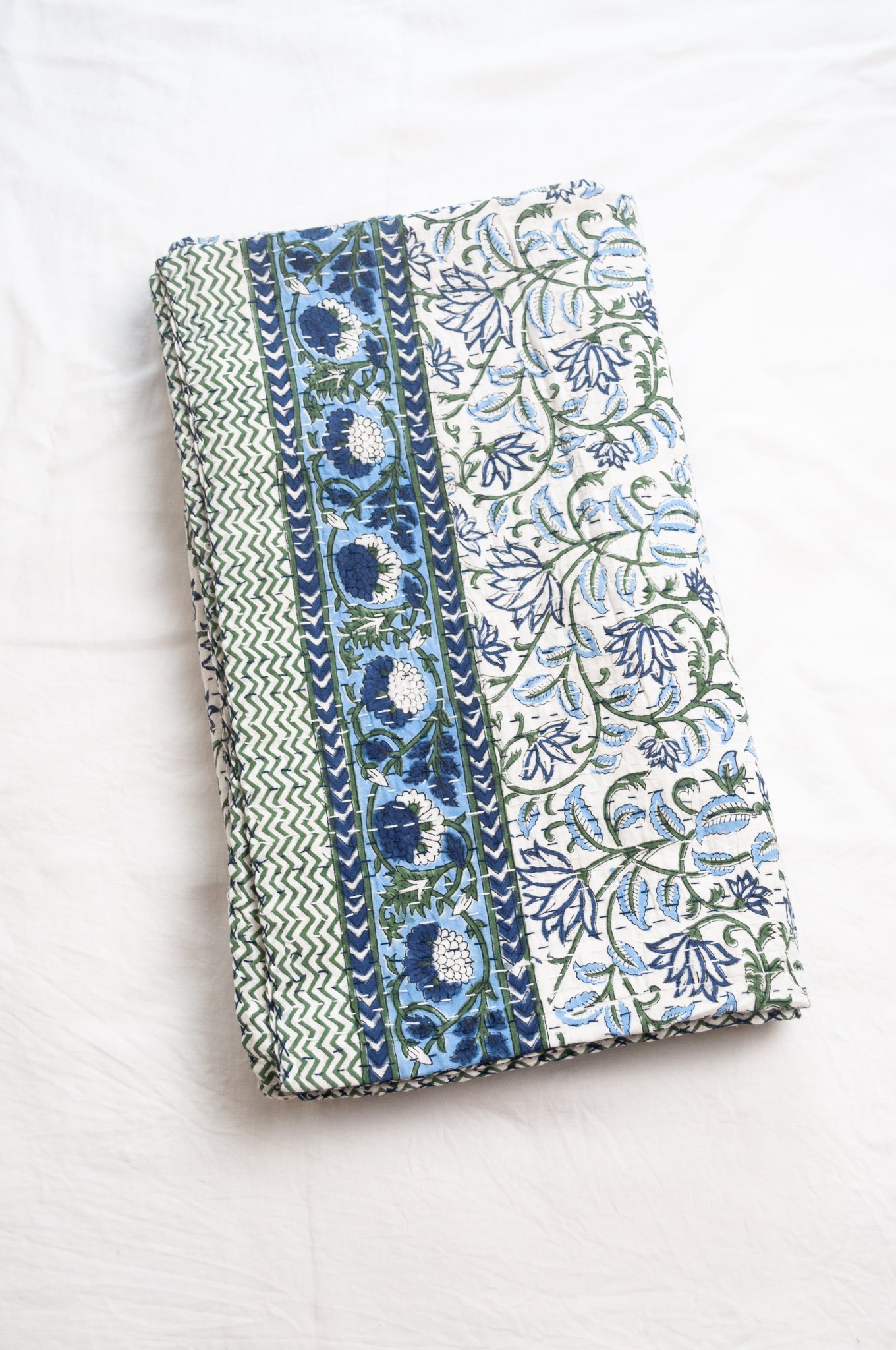 Kantha quilt blockprint pure cotton in floral blue and green on white pattern.