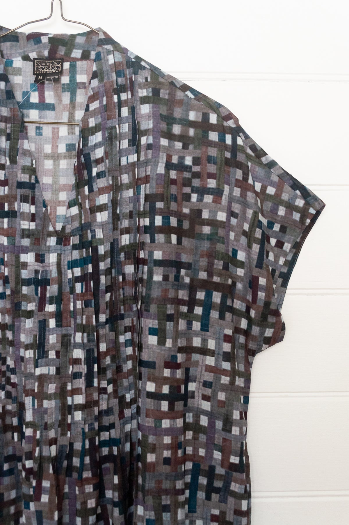 Neeru Kumar fine cotton pintucked  cap sleeved dress in charcoal and brown checks with teal highlights.