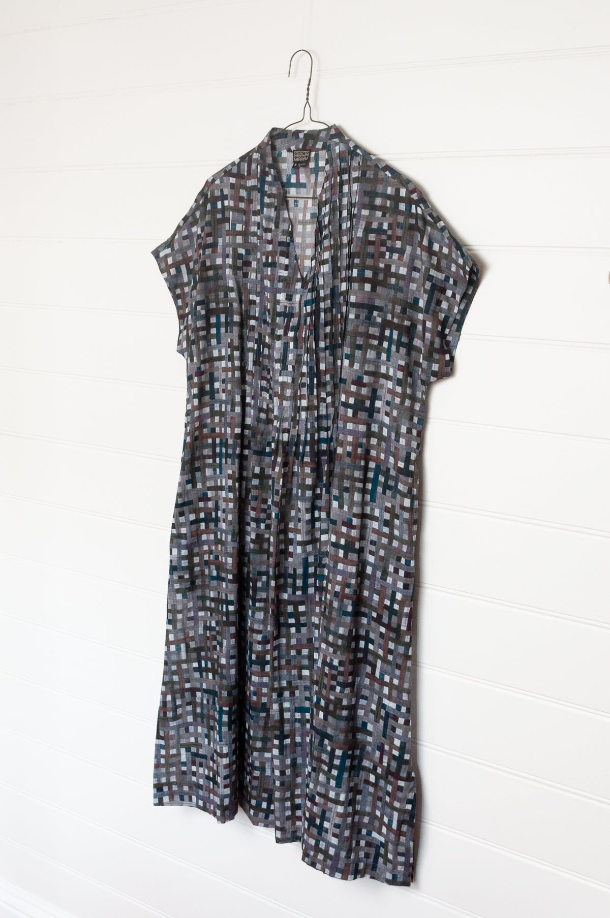 Neeru Kumar fine cotton pintucked  cap sleeved dress in charcoal and brown checks with teal highlights.