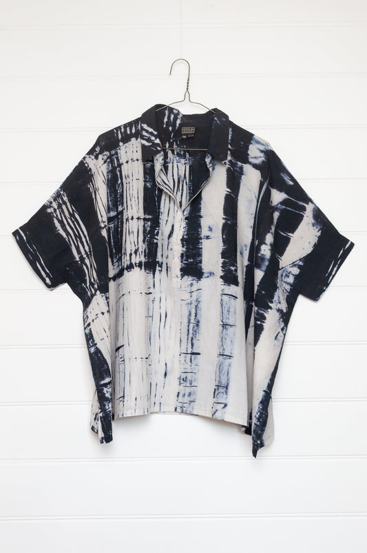 Neeru Kumar short-sleeve collared shirt with a black and white shibori tie-dye pattern.
