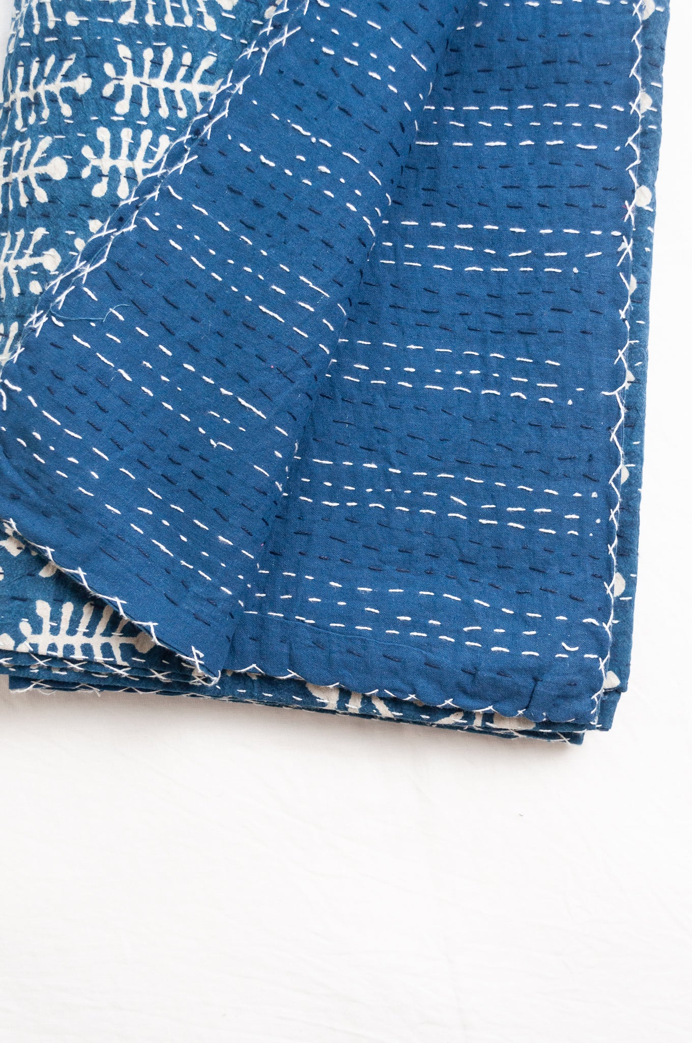 Indigo blue and white pure cotton kantha stitch bed quilt with fern design.