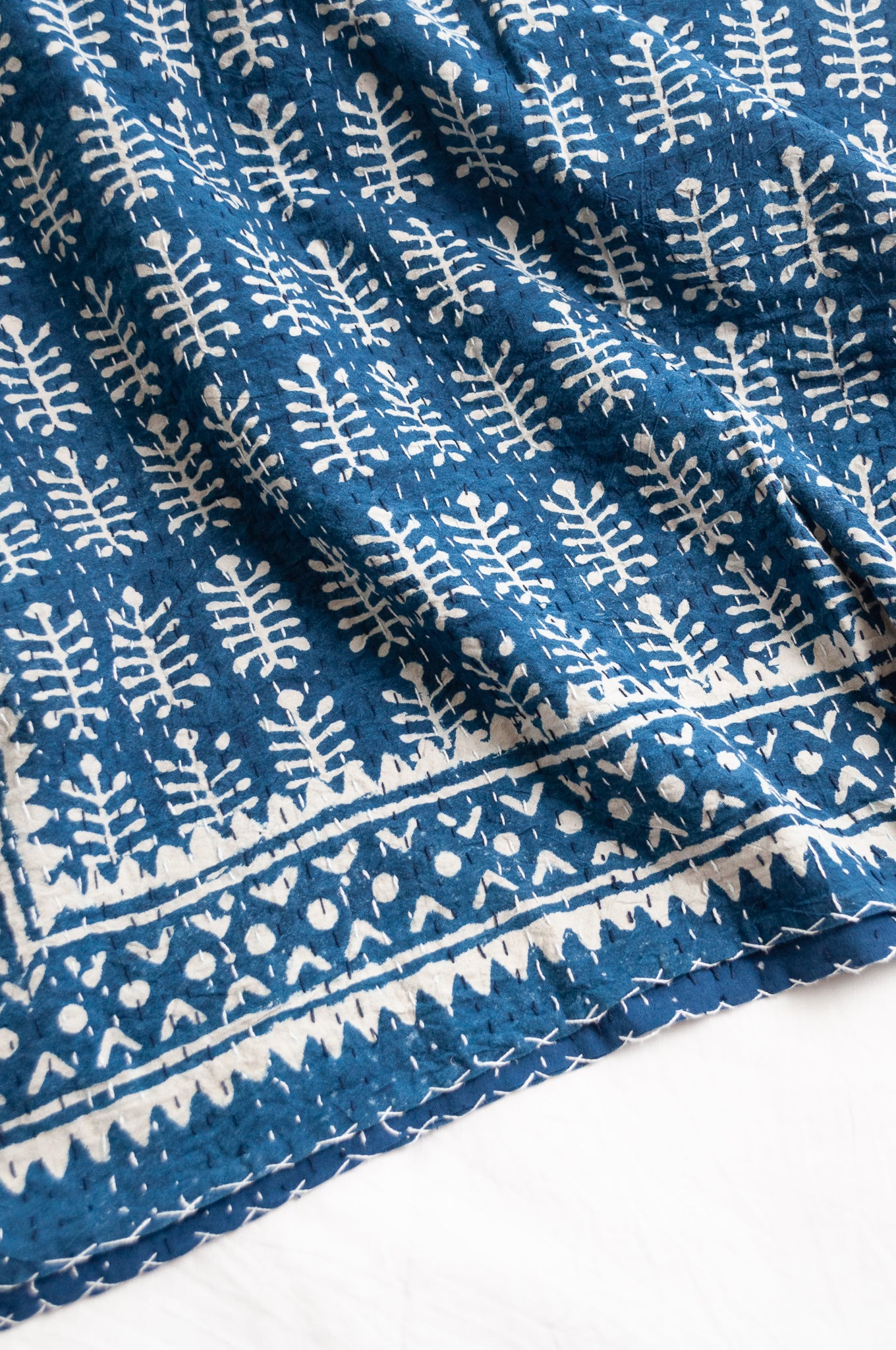 Indigo blue and white pure cotton kantha stitch bed quilt with fern design.