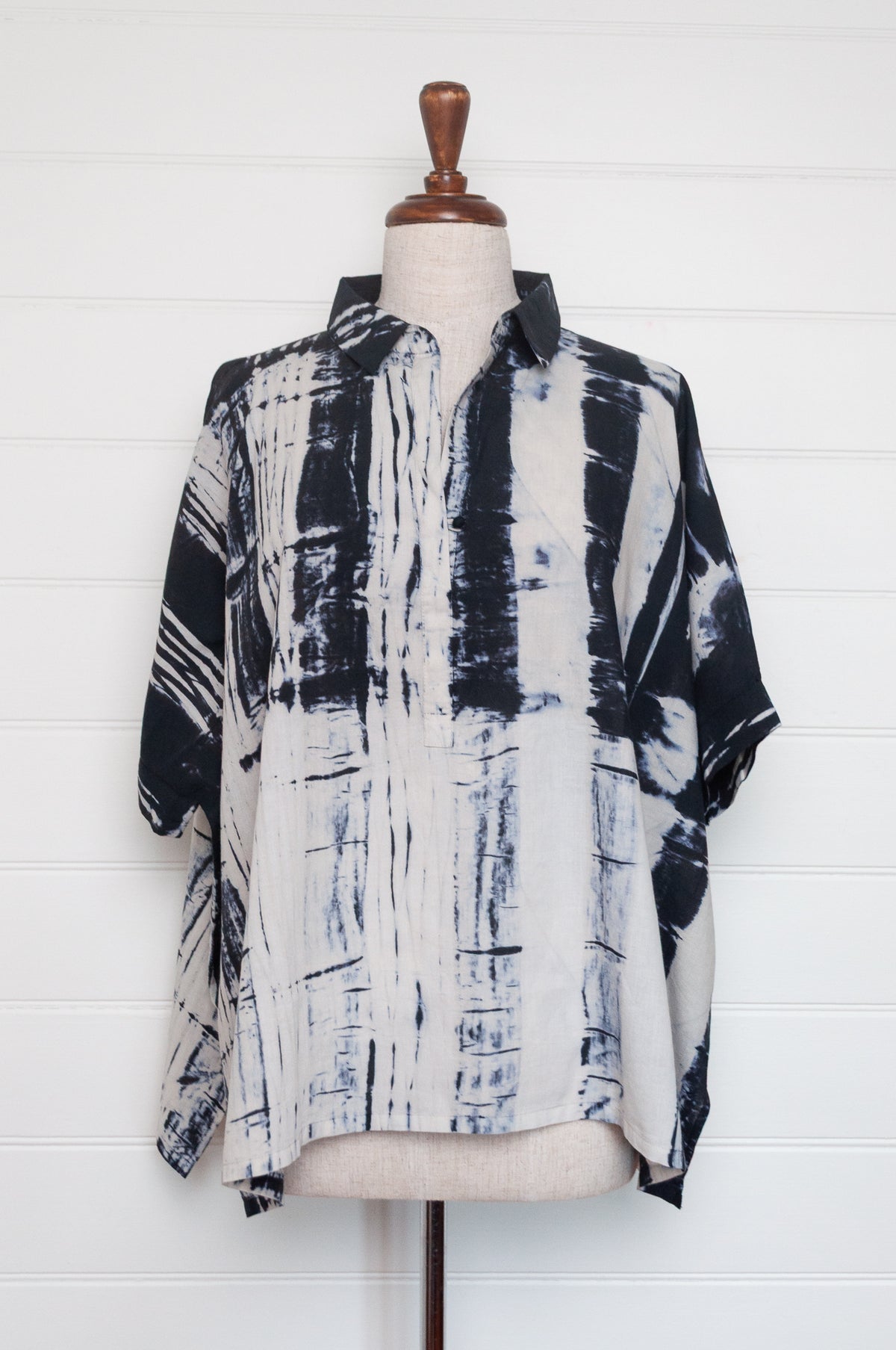Neeru Kumar short-sleeve collared shirt with a black and white shibori tie-dye pattern.