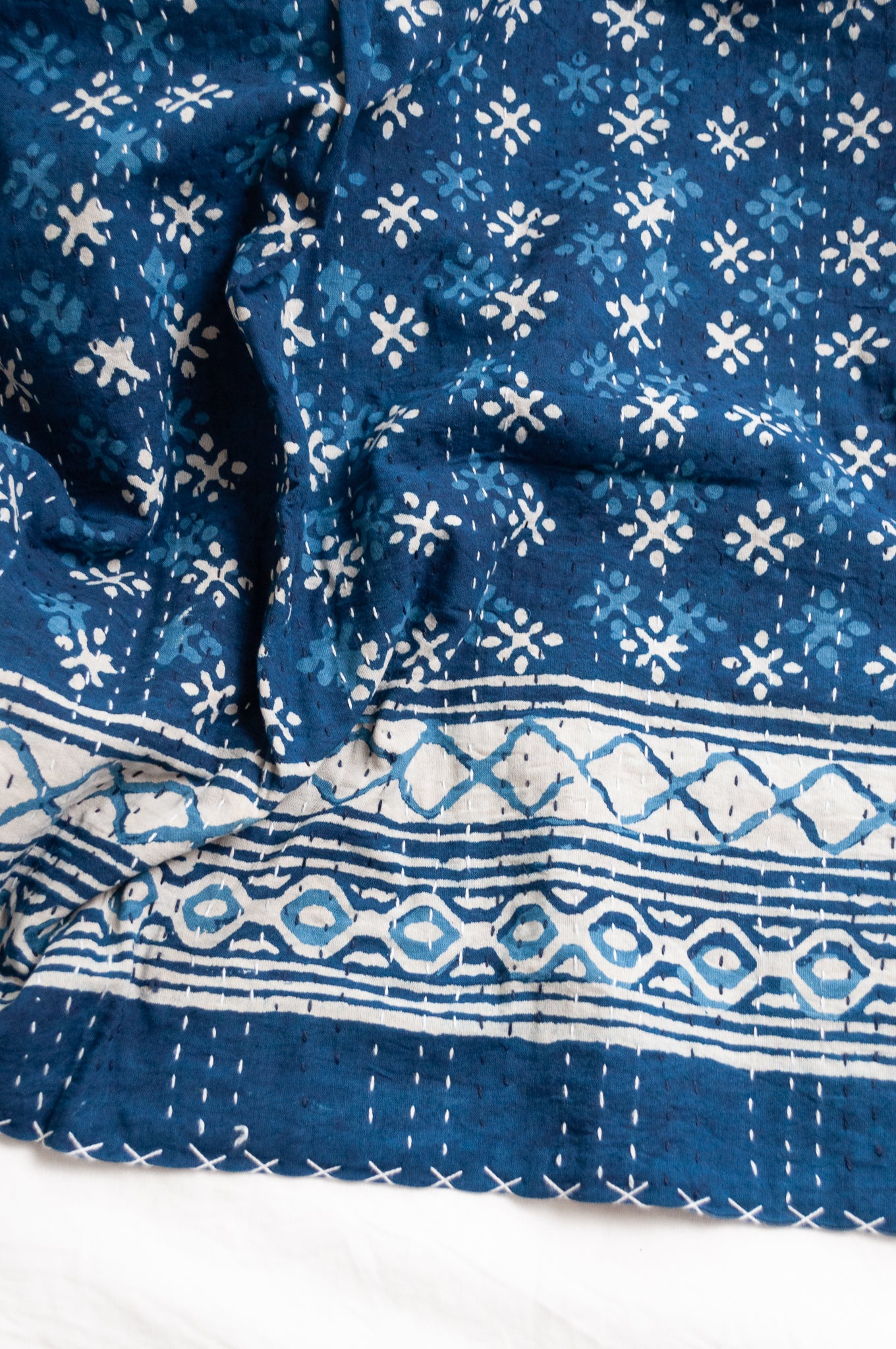 Indigo blue and white pure cotton kantha stitch bed quilt with diamond dot design.