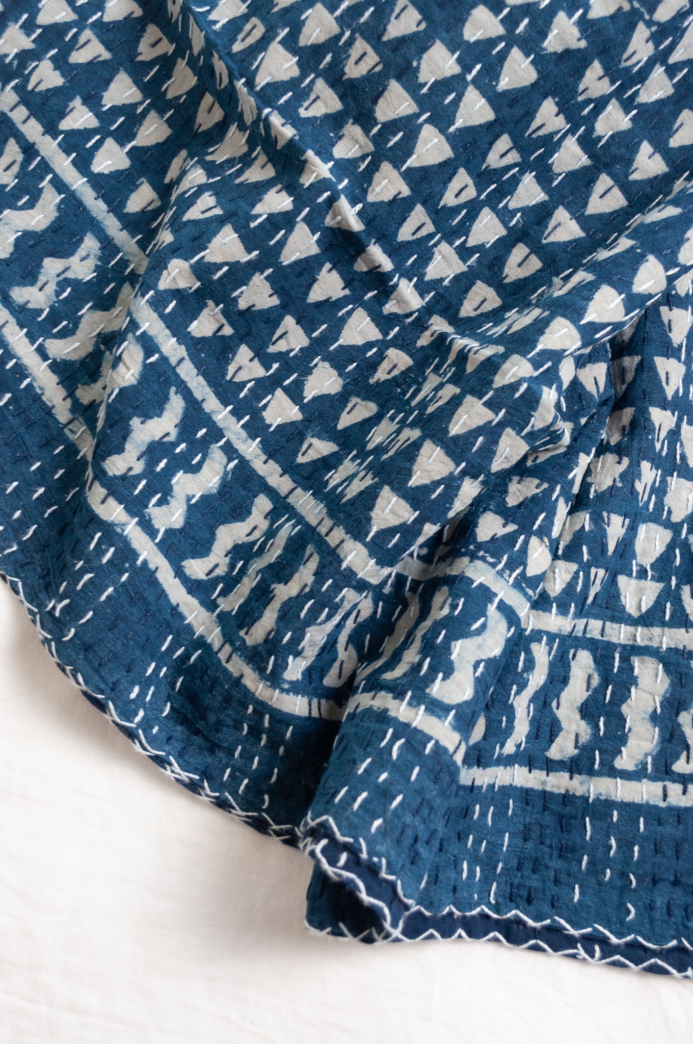 Indigo blue and white pure cotton kantha stitch bed quilt with triangle design.