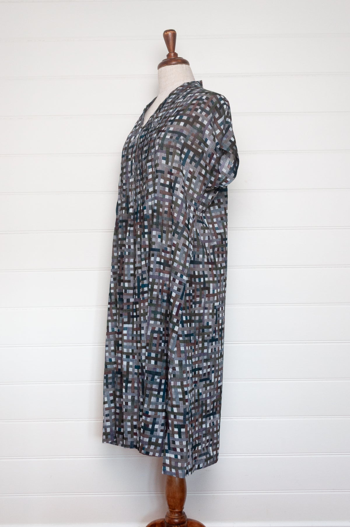 Neeru Kumar fine cotton pintucked  cap sleeved dress in charcoal and brown checks with teal highlights.