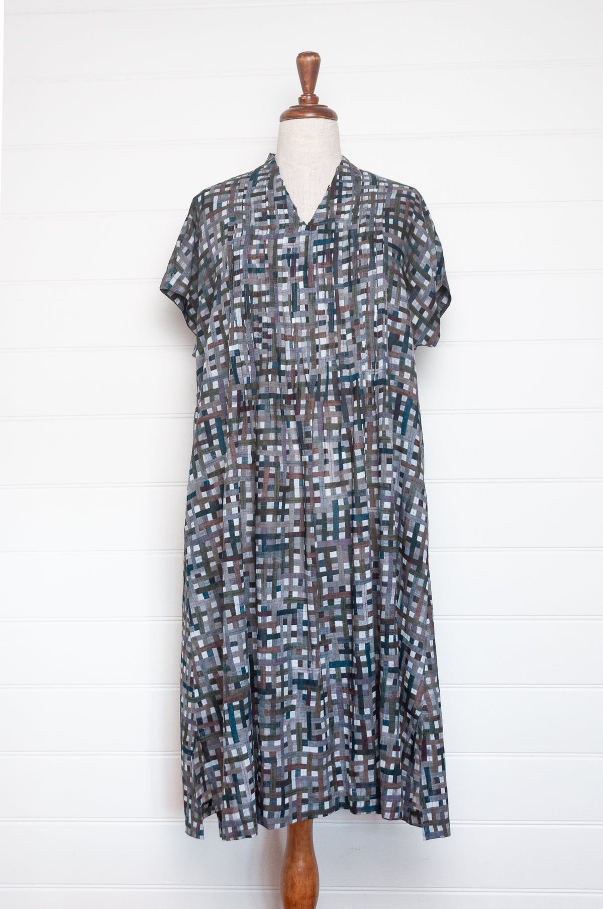 Neeru Kumar fine cotton pintucked  cap sleeved dress in charcoal and brown checks with teal highlights.