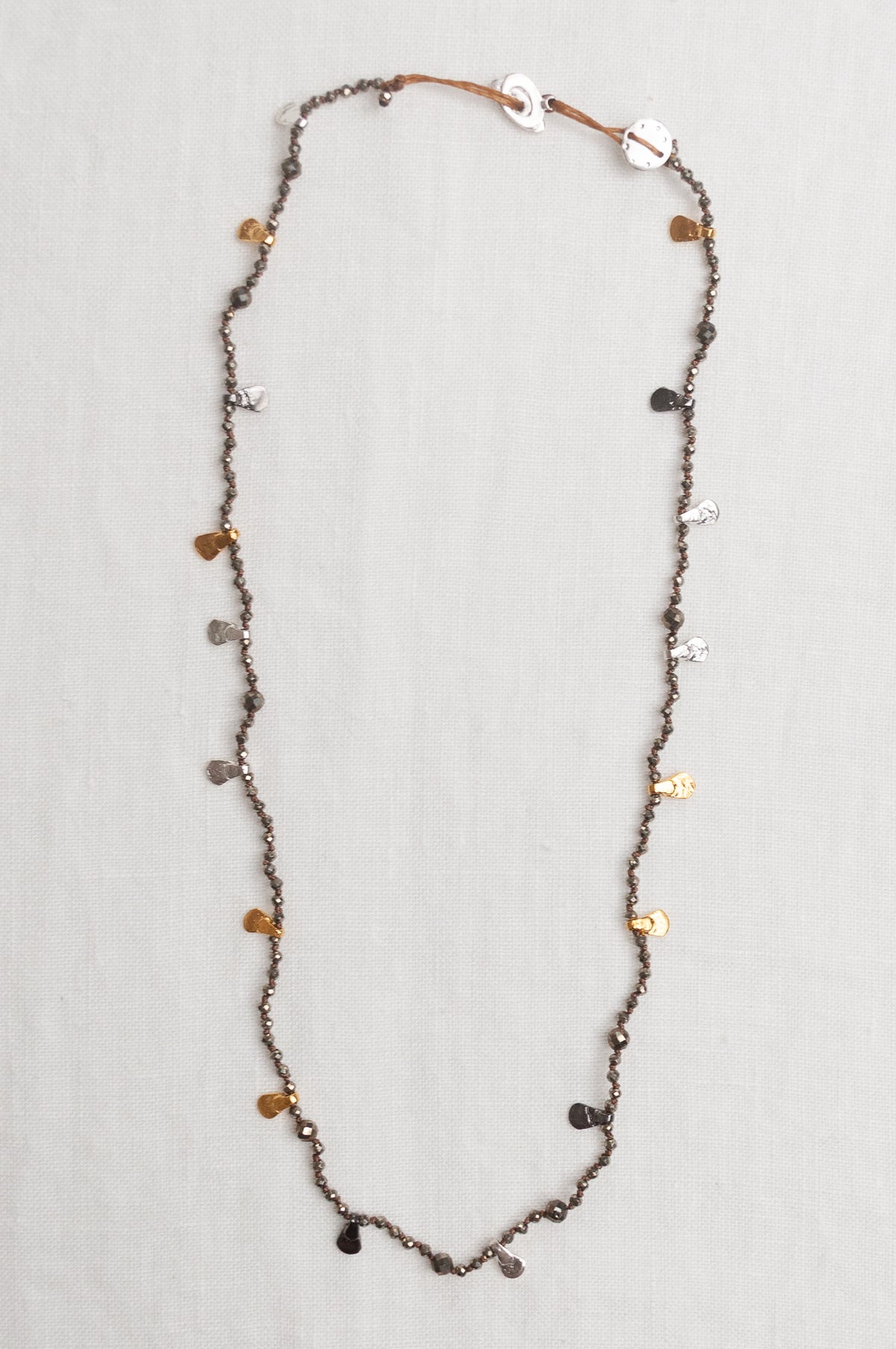 Mary Gaitani handmade pyrite necklace with silver and gold charms.