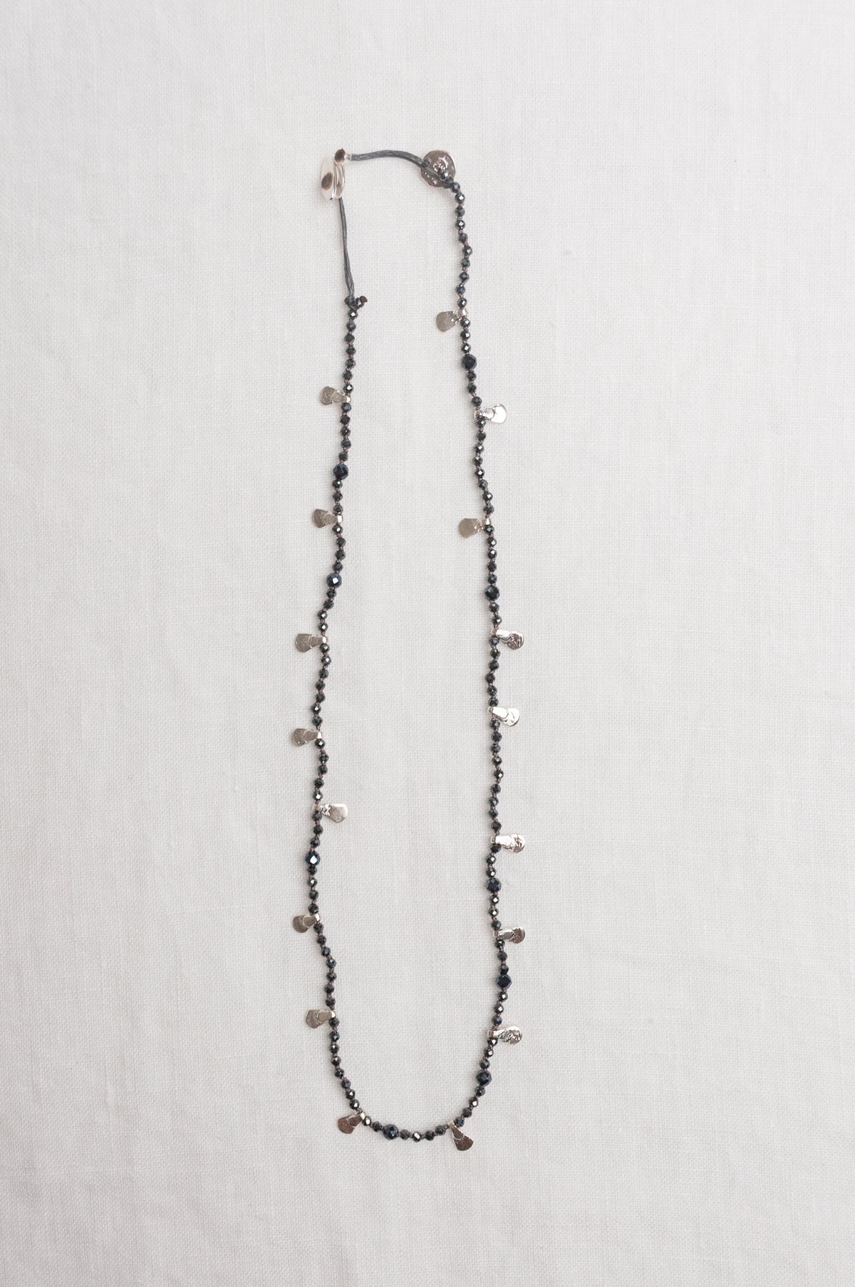 Mary Gaitani handmade grey spinels necklace with silver charms.