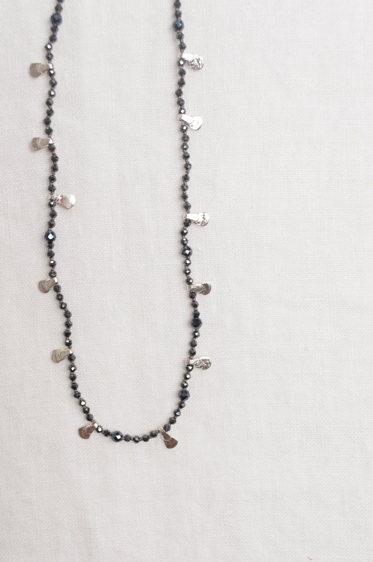 Mary Gaitani handmade grey spinels necklace with silver charms.