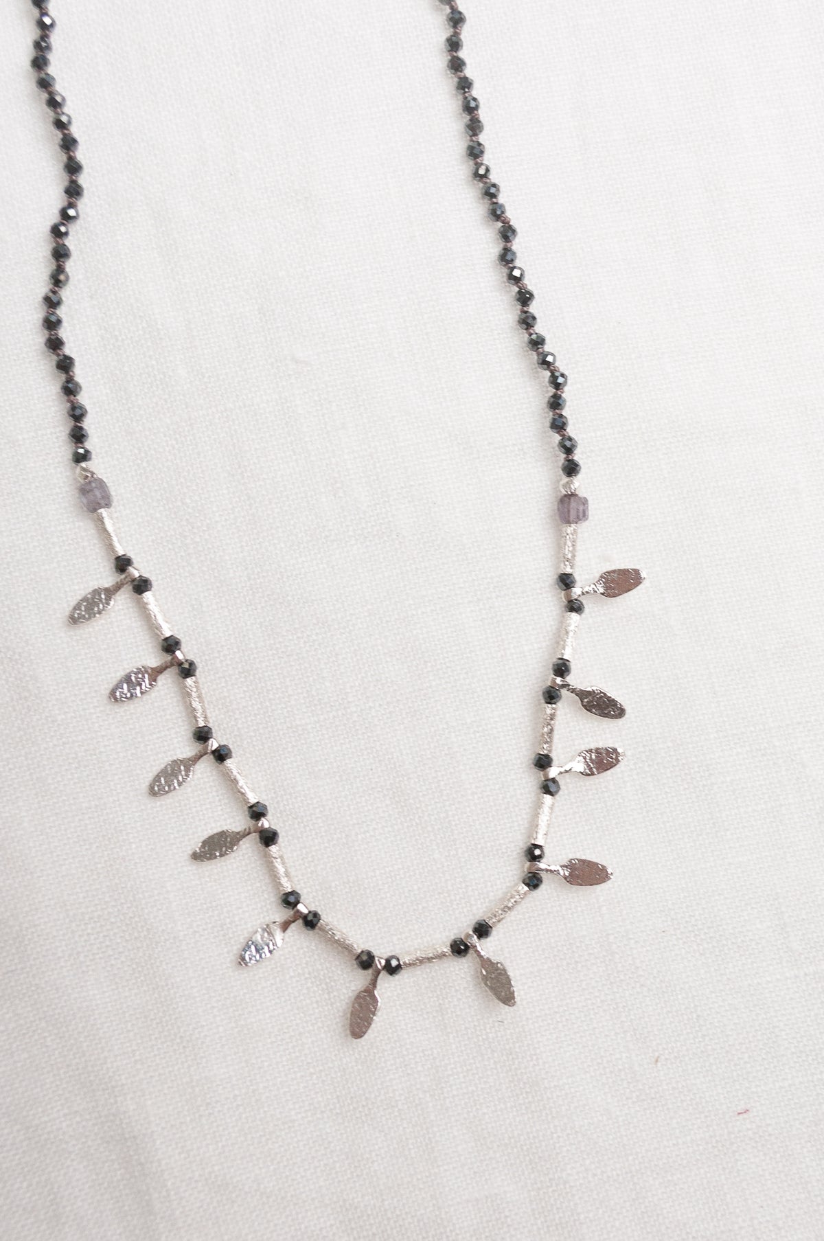 Mary Gaitani handmade grey spinels necklace with silver charms.