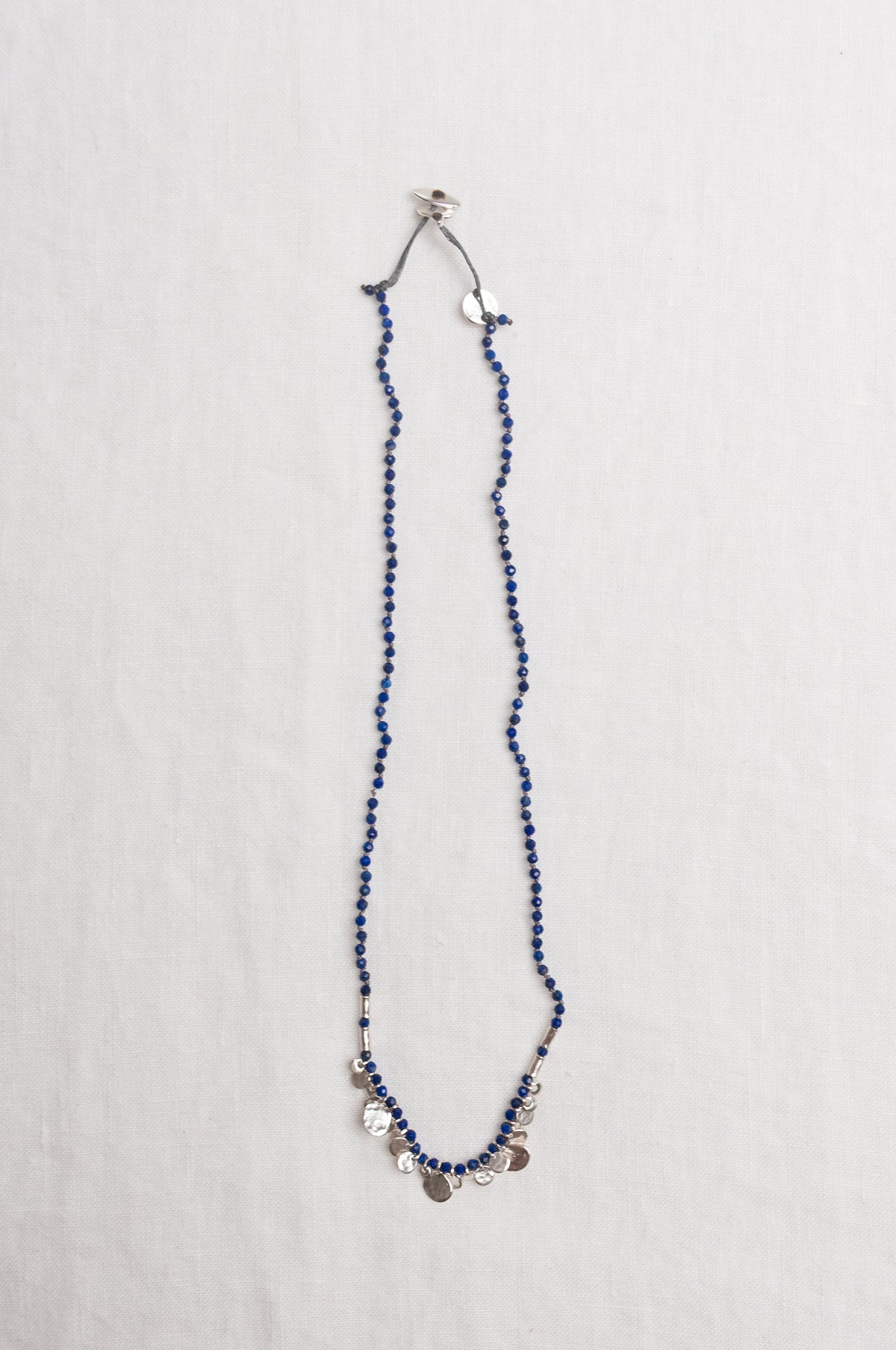 Mary Gaitani handmade lapis necklace with silver charms.