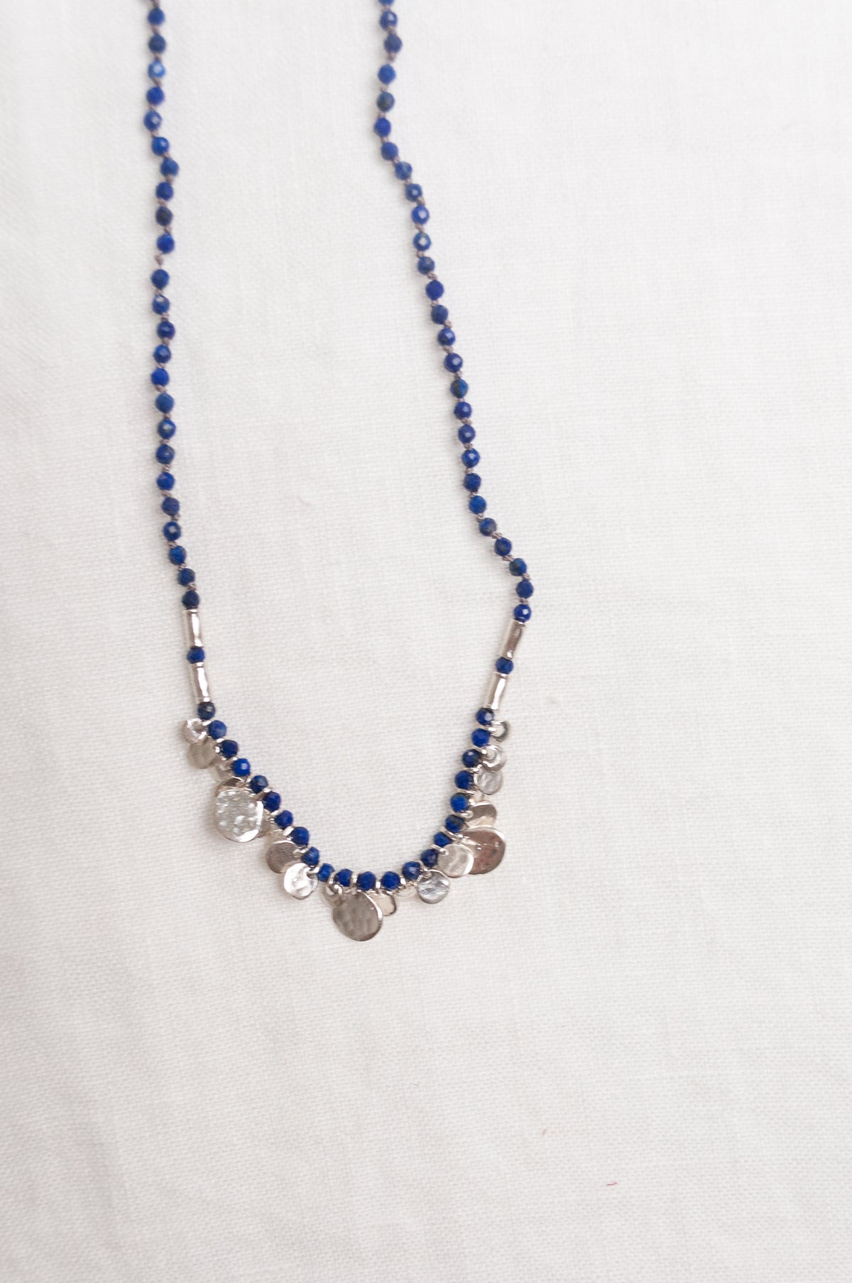 Mary Gaitani handmade lapis necklace with silver charms.