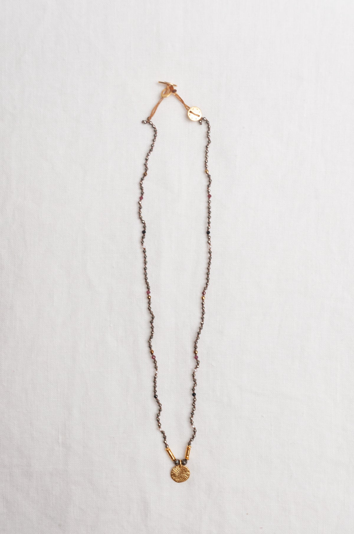 Mary Gaitani handmade pyrite necklace with gold charms.
