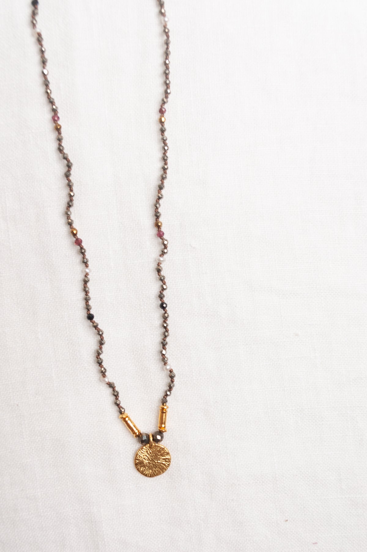 Mary Gaitani handmade pyrite necklace with gold charms.