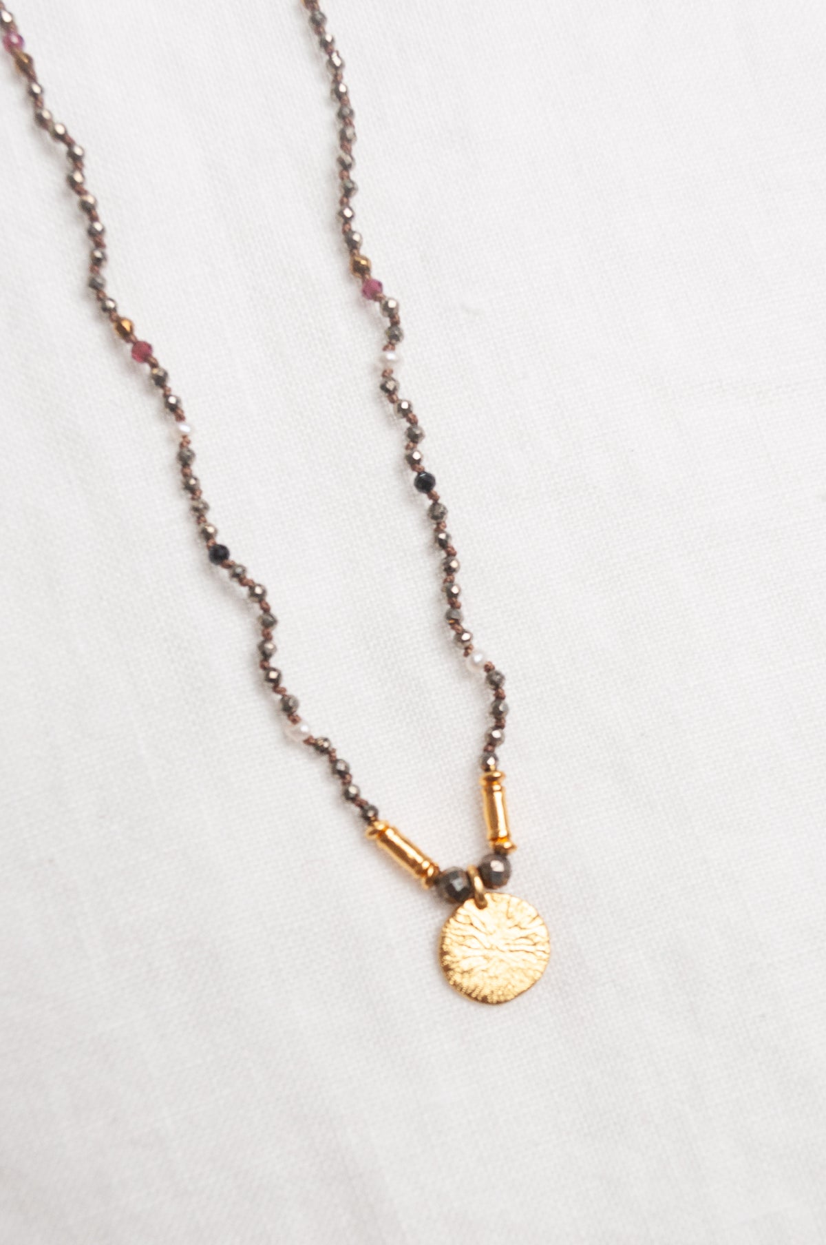 Mary Gaitani handmade pyrite necklace with gold charms.