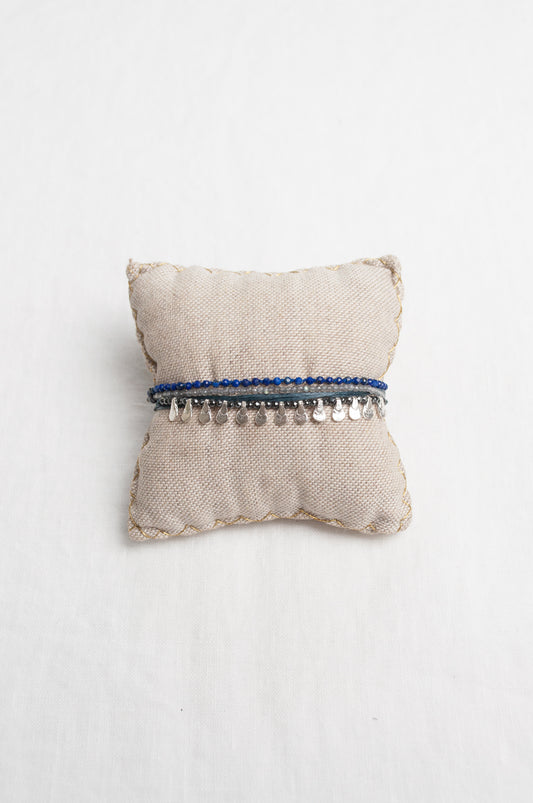Mary Gaitani hand tooled silver teardrop charms on navy cords with semi-precious stones.