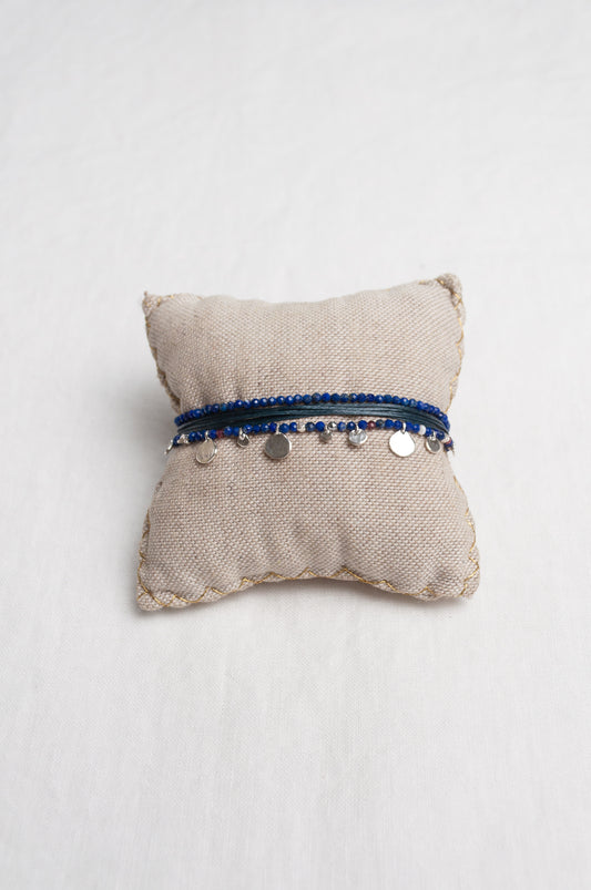 Mary Gaitani hand tooled silver charms on stranded cords with lapis beads.