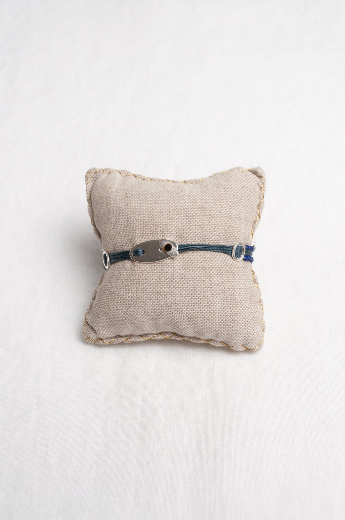 Mary Gaitani hand tooled silver charms on stranded cords with lapis beads.
