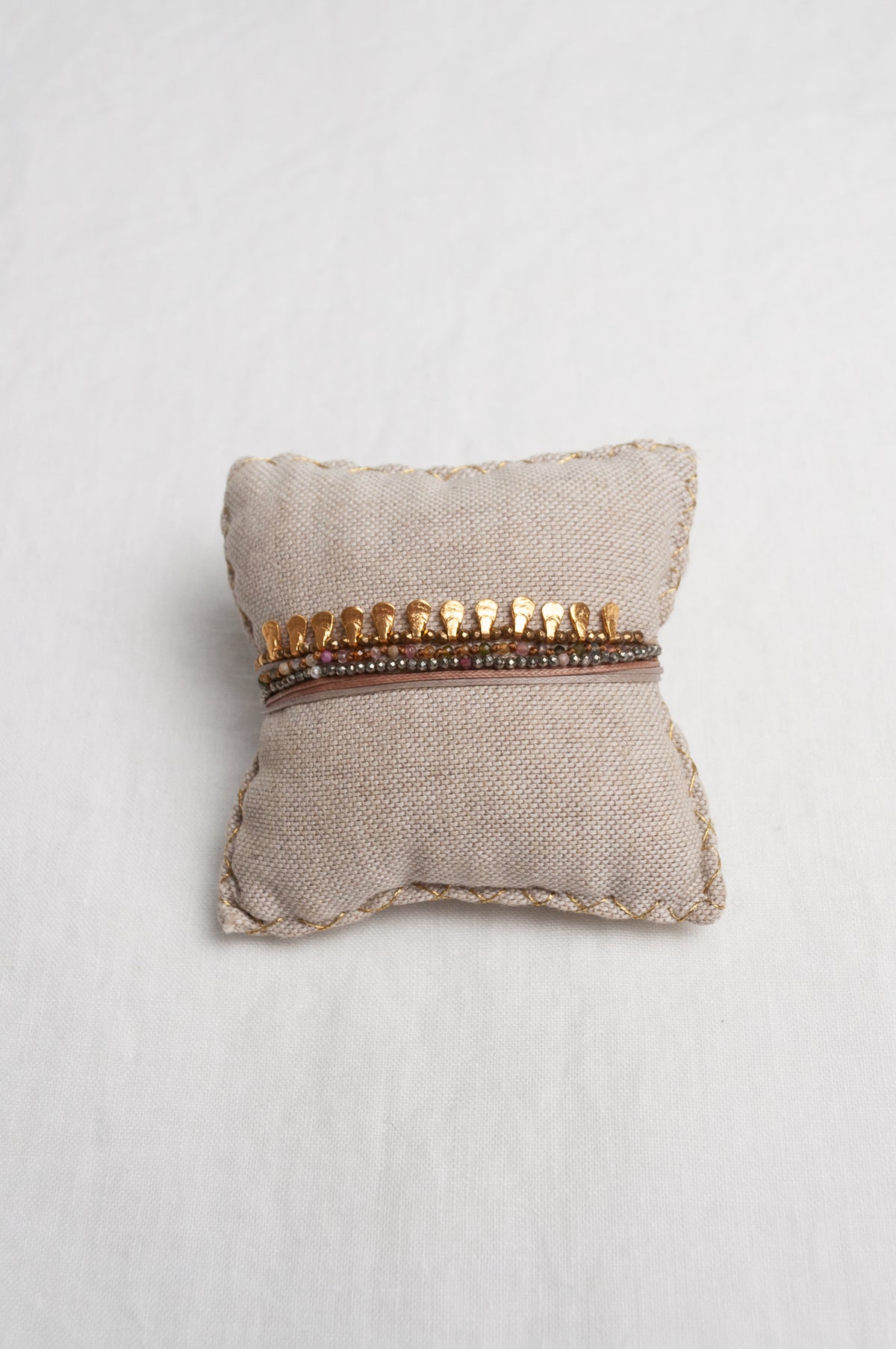 Mary Gaitani hand tooled gold teardrop charms on stranded cords with semi-precious stones.