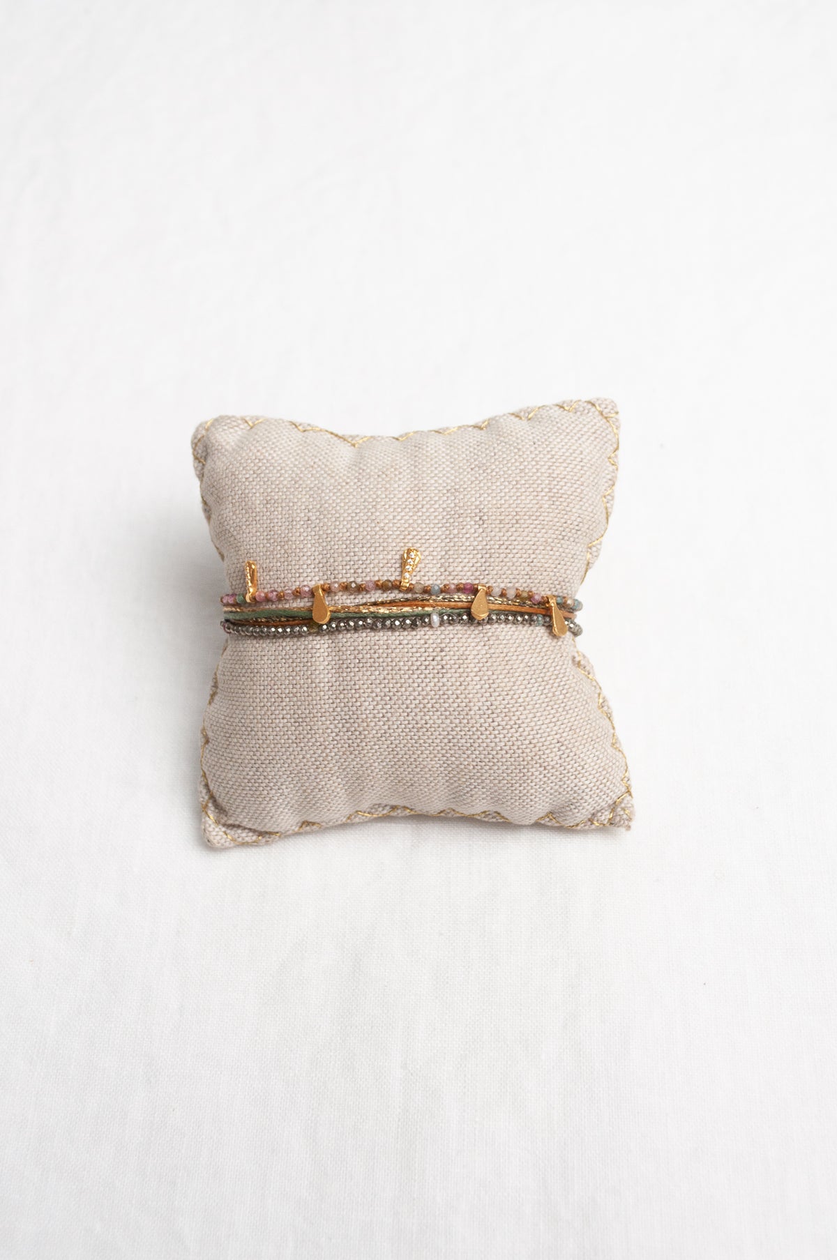 Mary Gaitani stranded wax cord bracelet with semi-precious stones and gold teardrop charms.