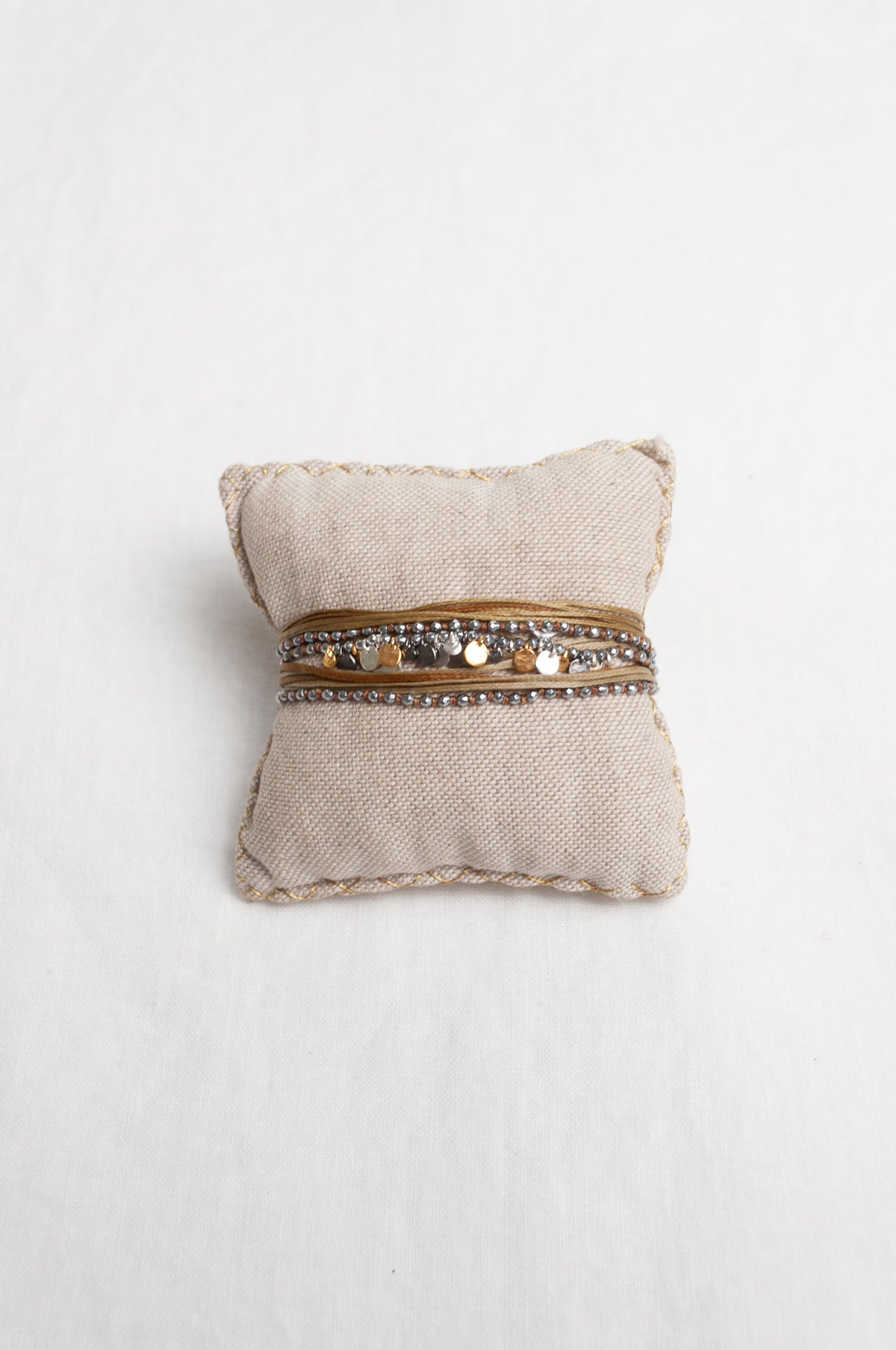 Mary Gaitani stranded wax cord bracelet with semi-precious stones and gold and silver charms.