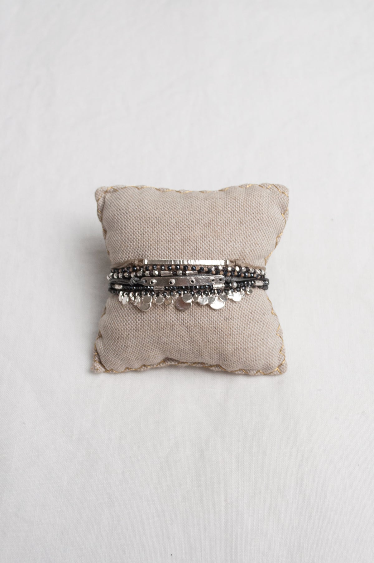 Mary Gaitani stranded wax cord bracelet with semi-precious stones and silver charms.
