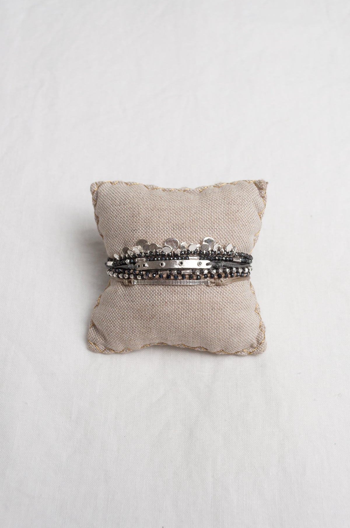 Mary Gaitani stranded wax cord bracelet with semi-precious stones and silver charms.