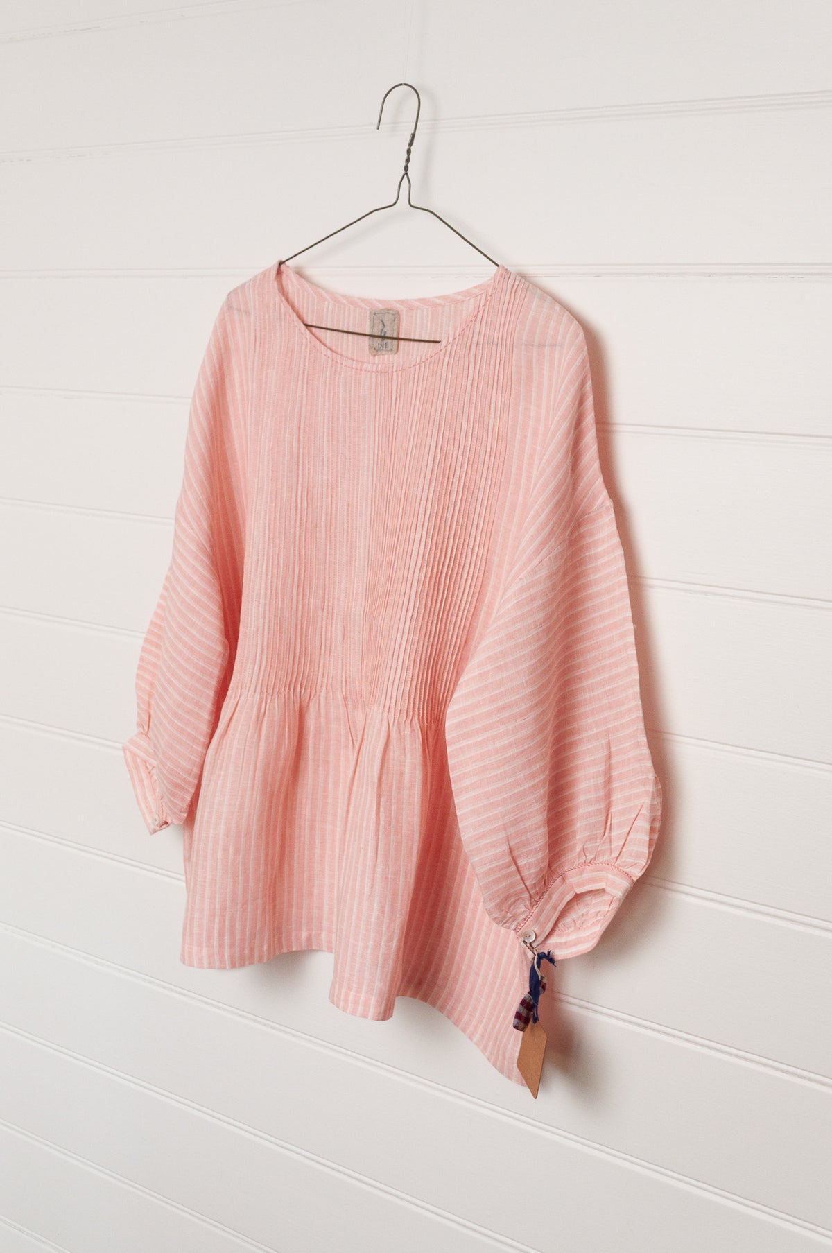 DVE Anisha pintuck linen top in rose pink and white stripe, with three quarter sleeves and hand stitched details.