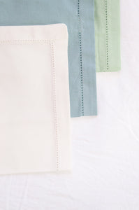 Plain cotton napkins with faggot hem detail in three colours, white, celadon and sage.