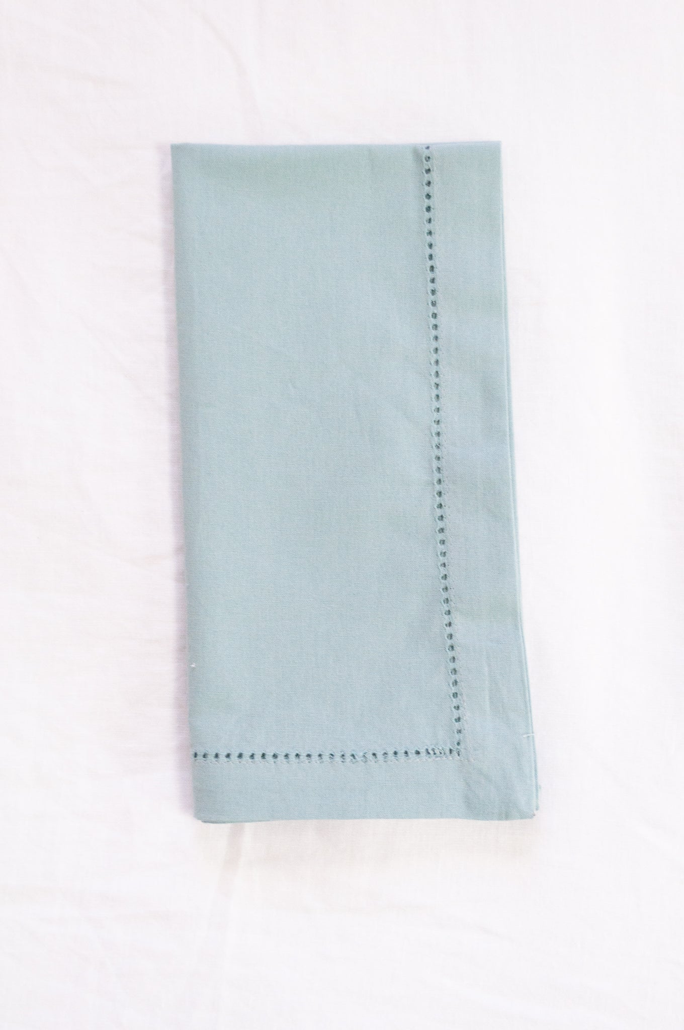 Plain cotton napkins with faggot hem detail in celadon.