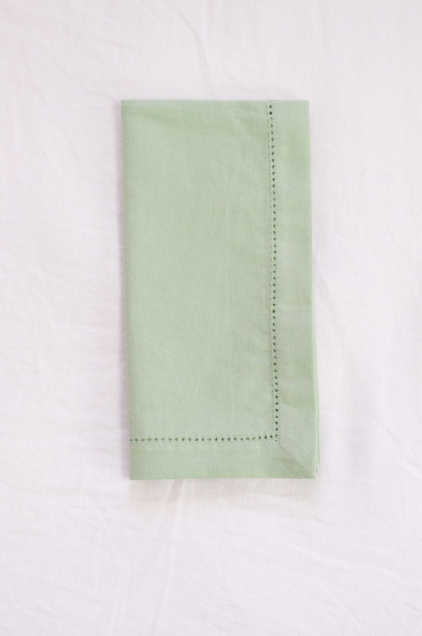 Plain cotton napkins with faggot hem detail in sage.