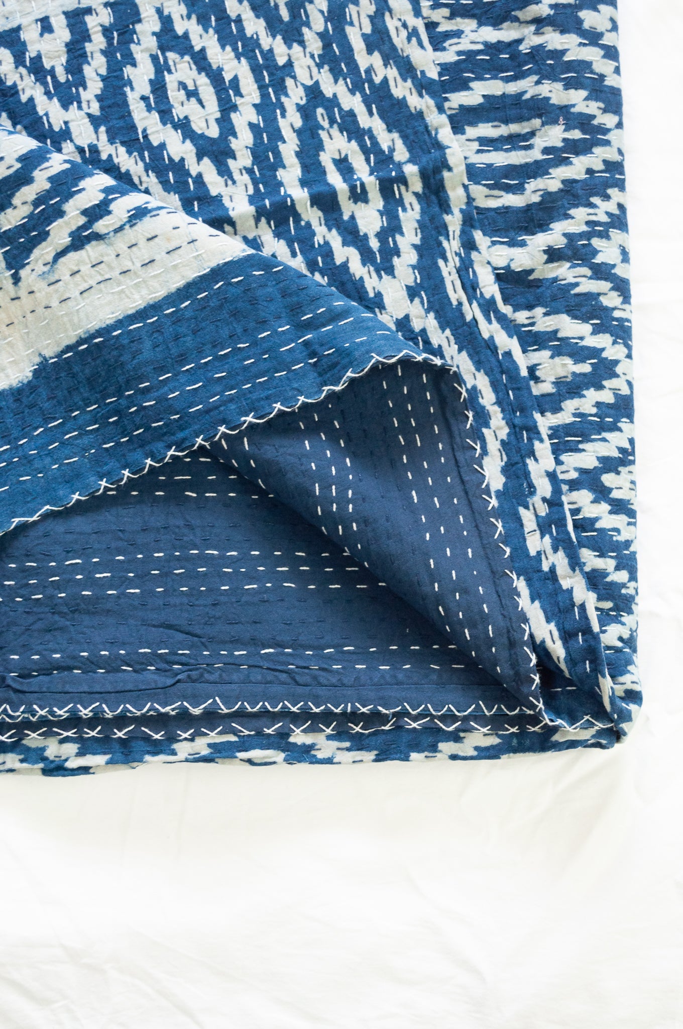 Indigo blue and white ikat print blockprint kantha quilt.