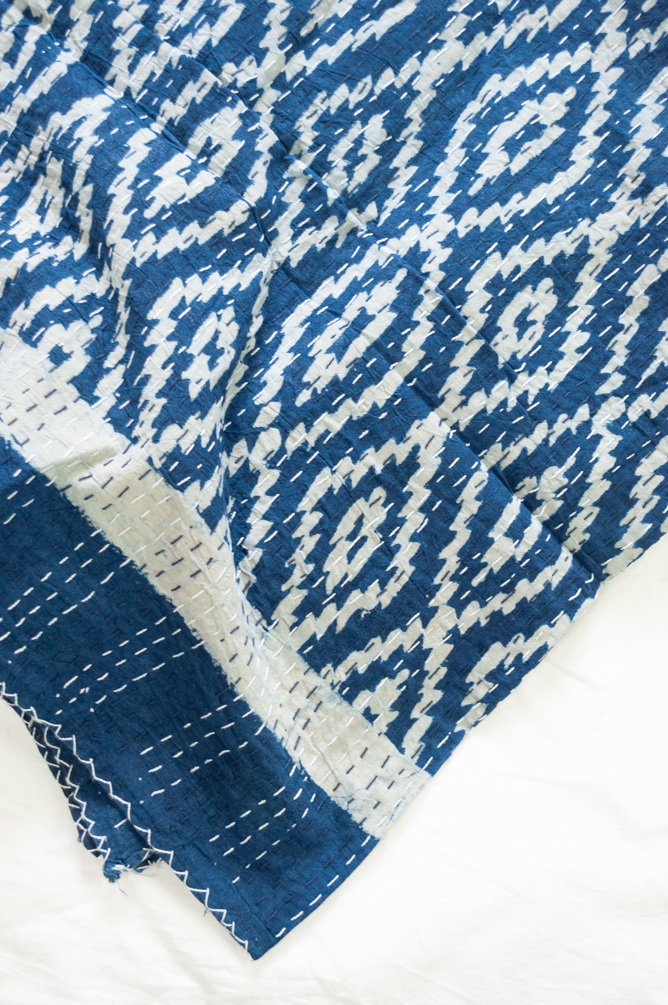 Indigo blue and white ikat print blockprint kantha quilt.
