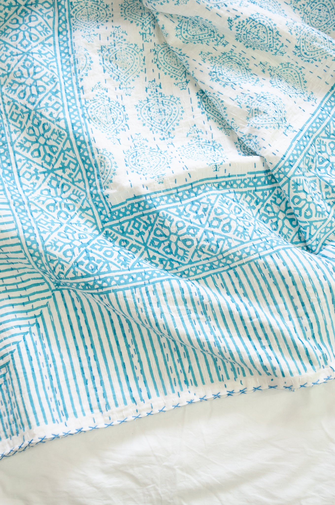 Aqua blue on white Mughal motif blockprint kantha quilt.