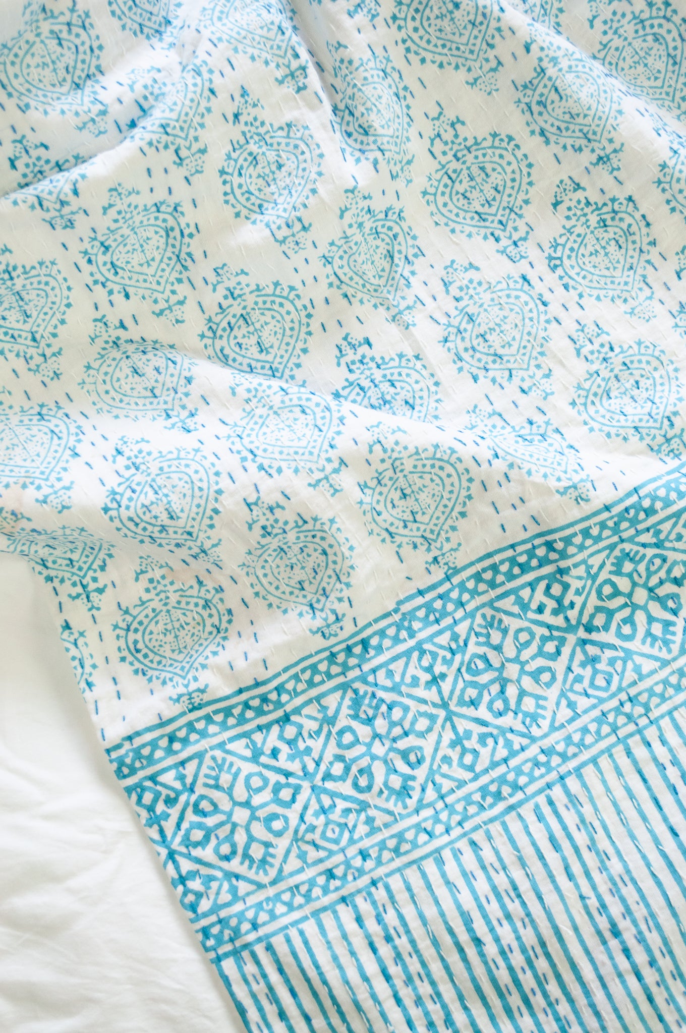 Aqua blue on white Mughal motif blockprint kantha quilt.