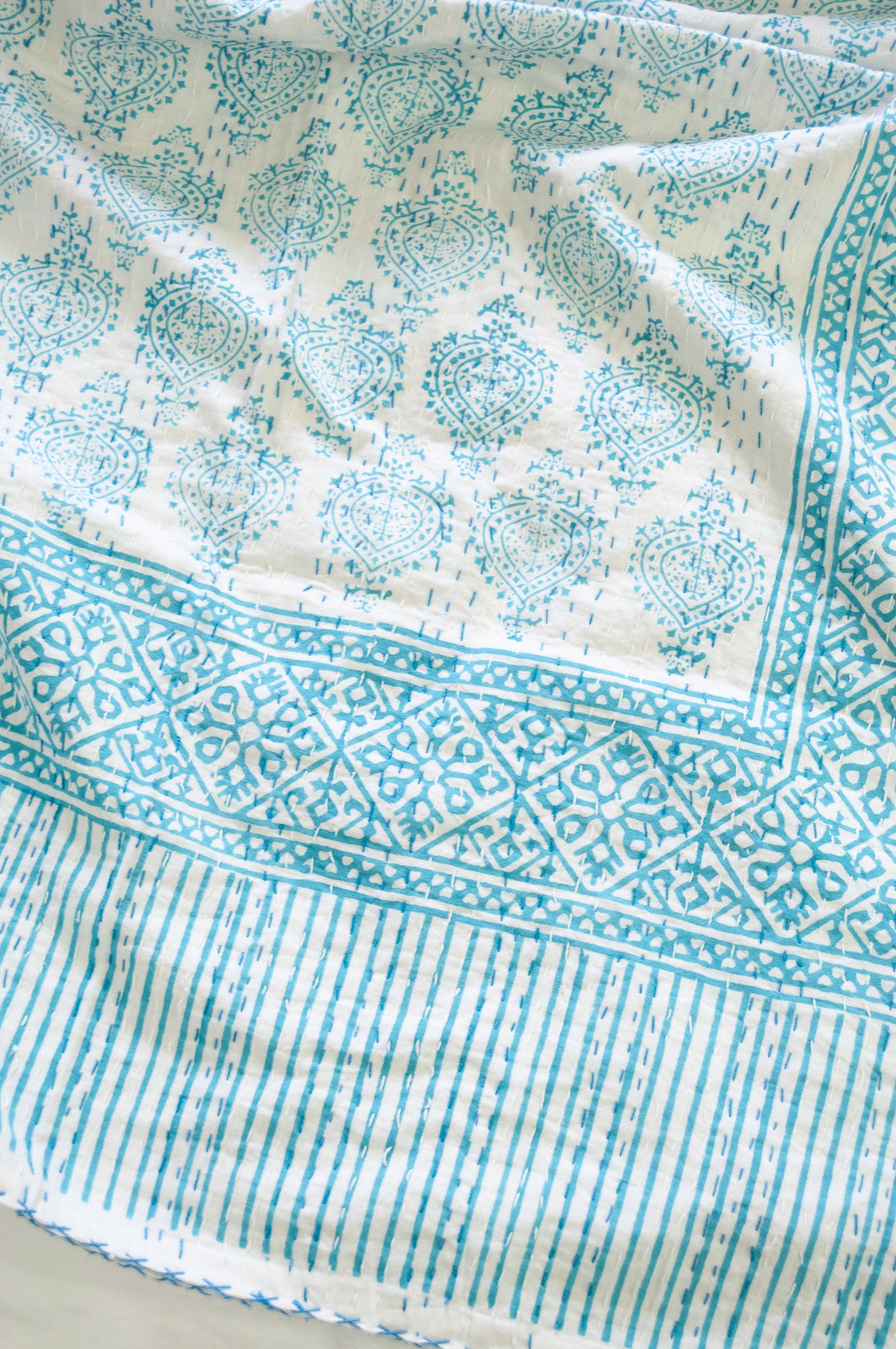 Aqua blue on white Mughal motif blockprint kantha quilt.